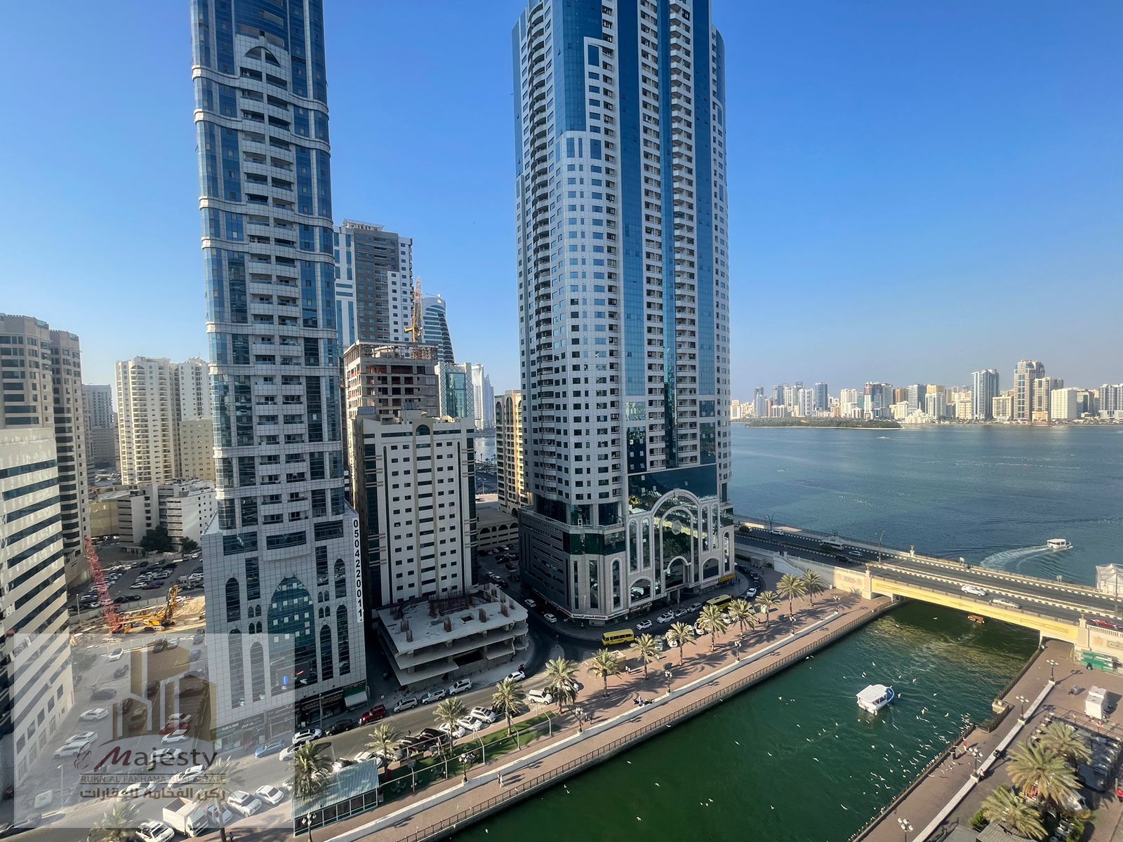 For investors and lovers of tourist places, an apartment in the Emirate of Sharjah, Al Majaz 3 area, Al Qasba Canal, with a front view of Al Qasba Can