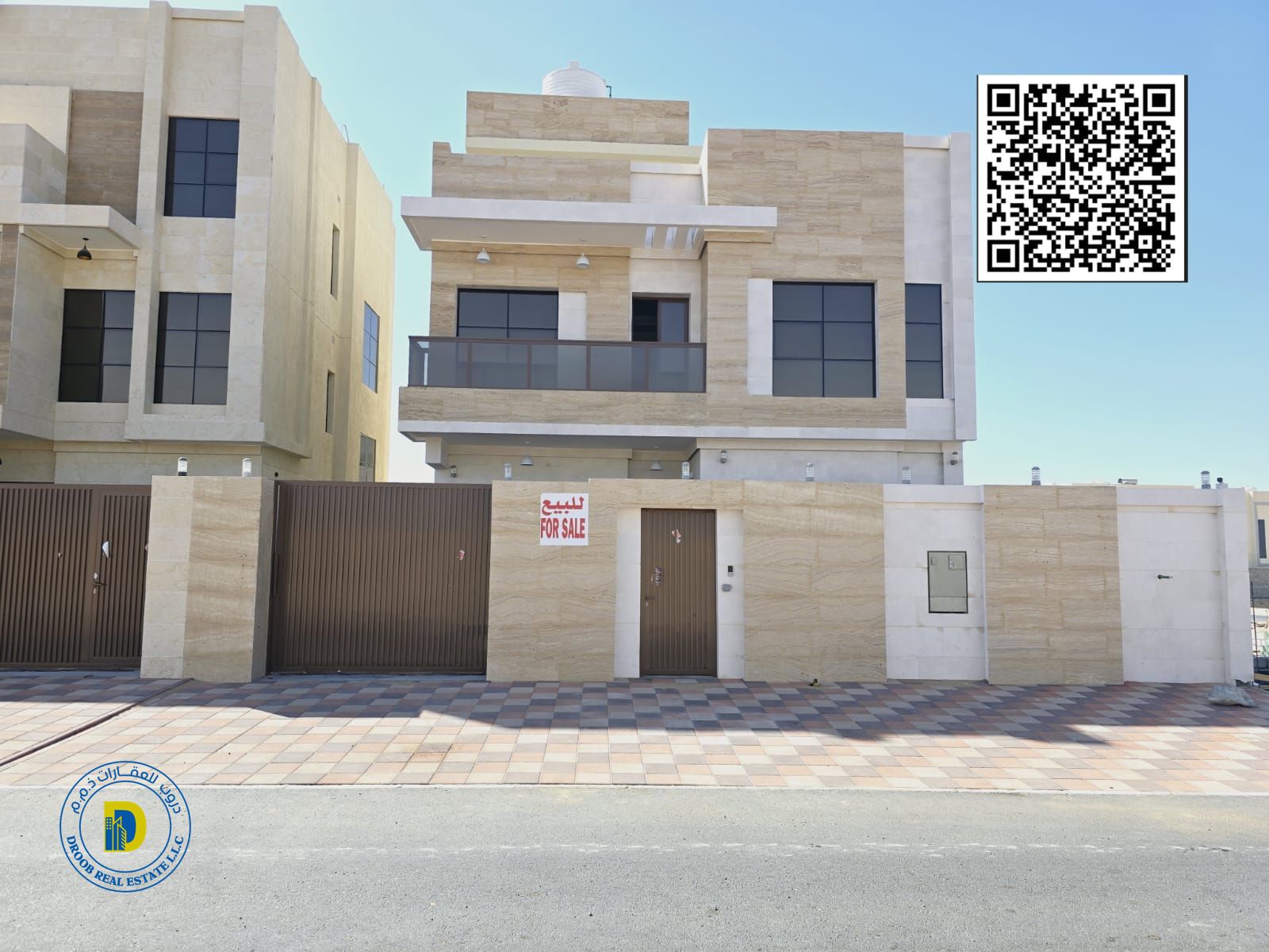 For sale in Al Bahia, Ajman, a modern villa with 5 rooms and a roof. The price includes registration and ownership fees.