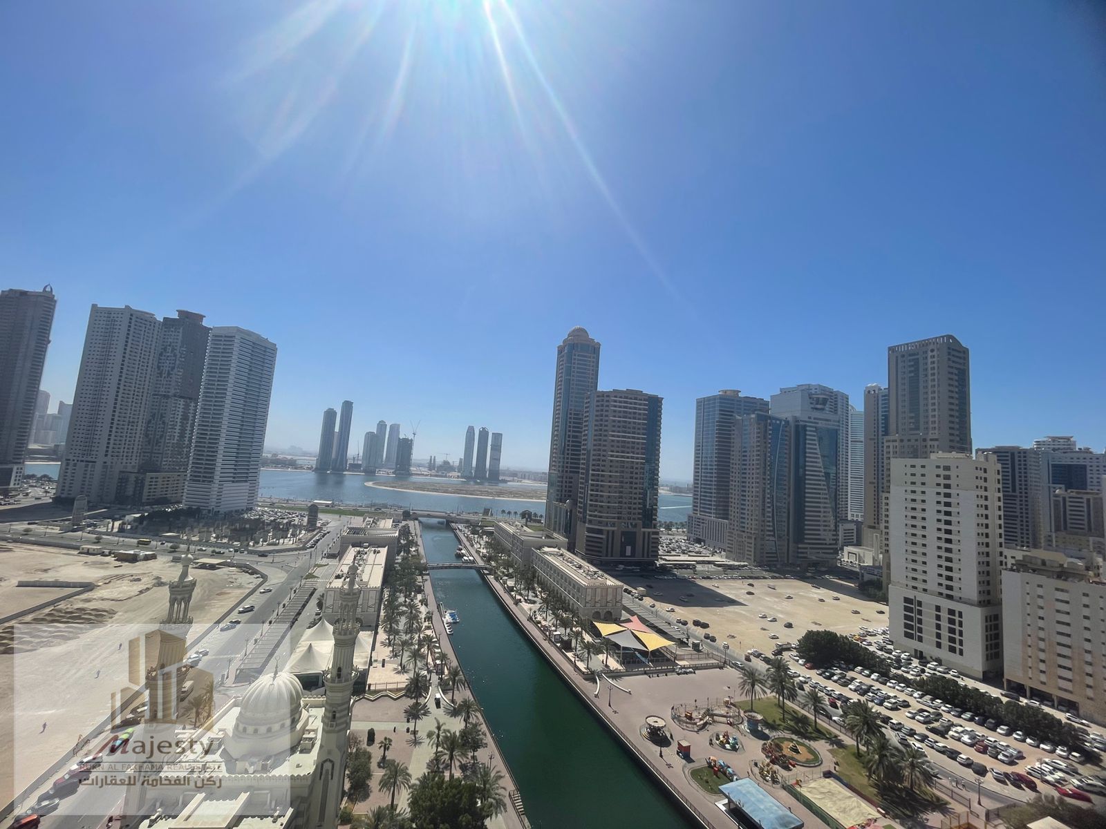 For sale, an apartment with a distinctive open view of Al Qasba Canal and Al Mamzar Lake, with a panoramic view of the entire apartment in Sharjah, Al
