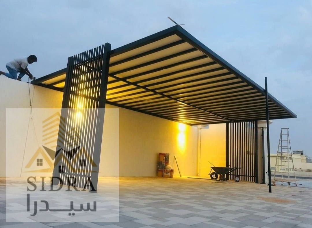 A luxurious villa with a modern design and automatic gate.