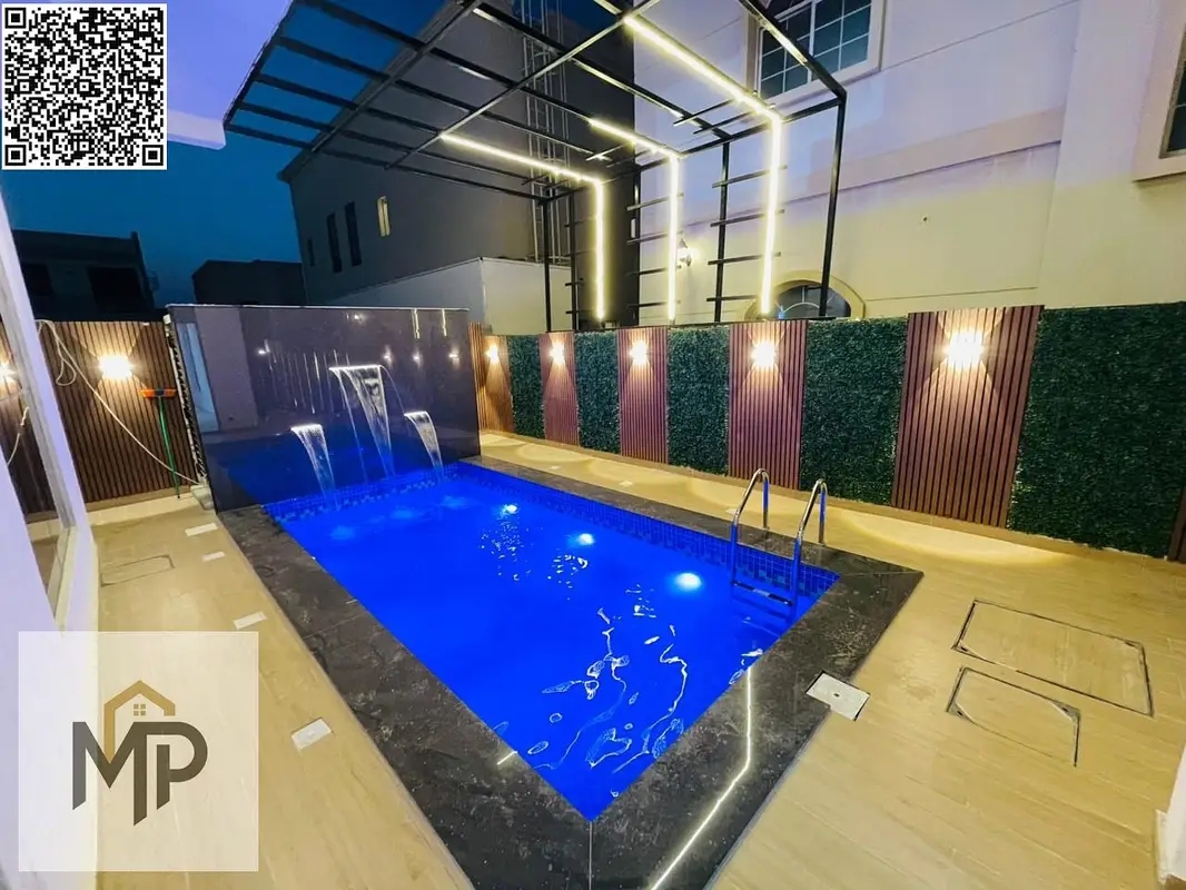 For sale in Al Zahia area, Ajman, a 4-room corner villa with a roof and a swimming pool, including registration fees, super deluxe finishing, freehold