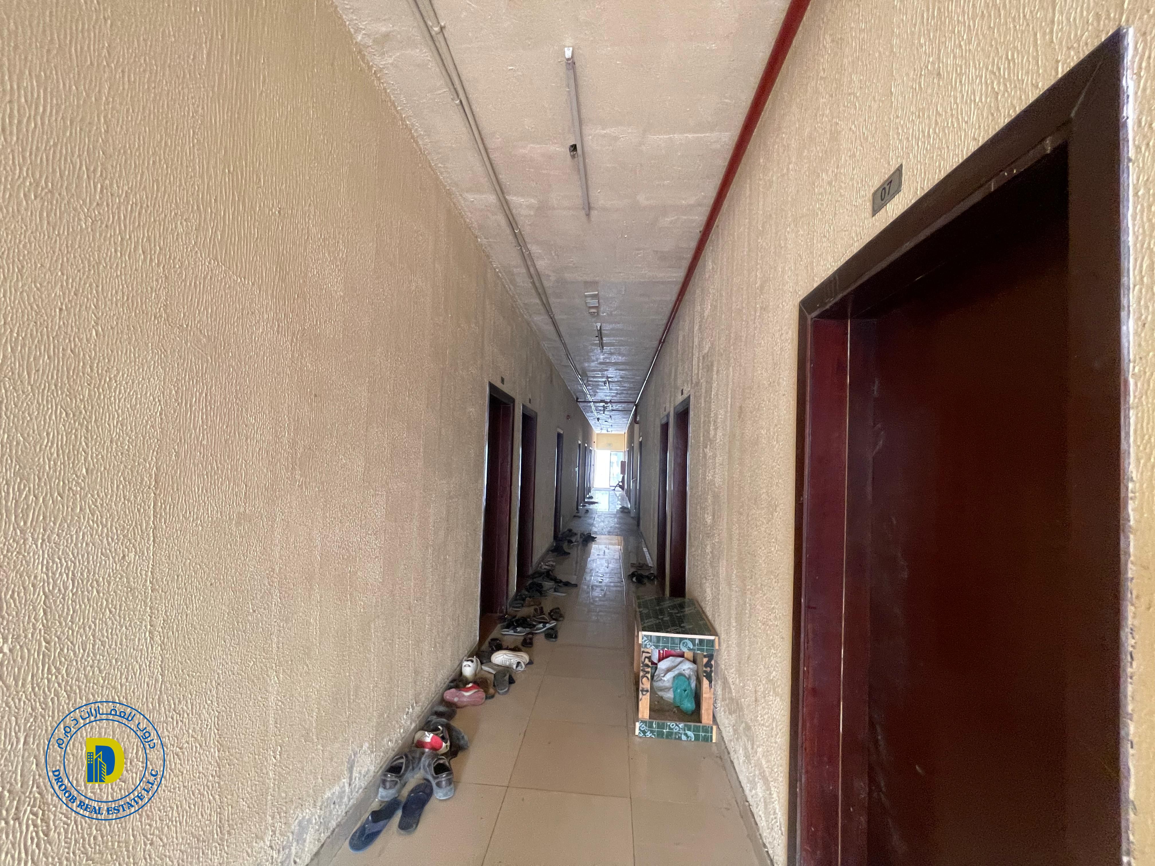 For sale in Al Jurf Industrial 2, Ajman, a large plot of land with workers’ housing and land suitable for building 5 shops at an excellent price