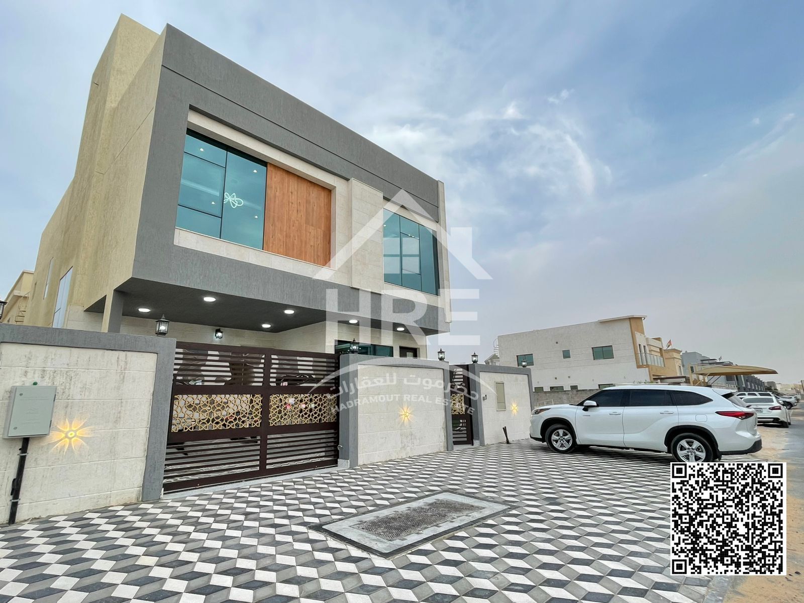 Own a 6-bedroom villa with a stone facade and internal and external parking spaces for AED 2,100,000, including services.