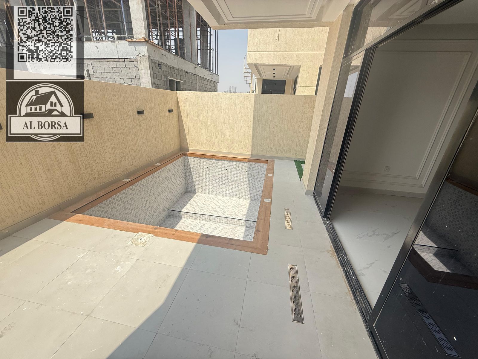 For sale, a villa in Al Helio 2, Ajman,4 master bedrooms, a living room, two halls, a maid's room, and a swimming pool.