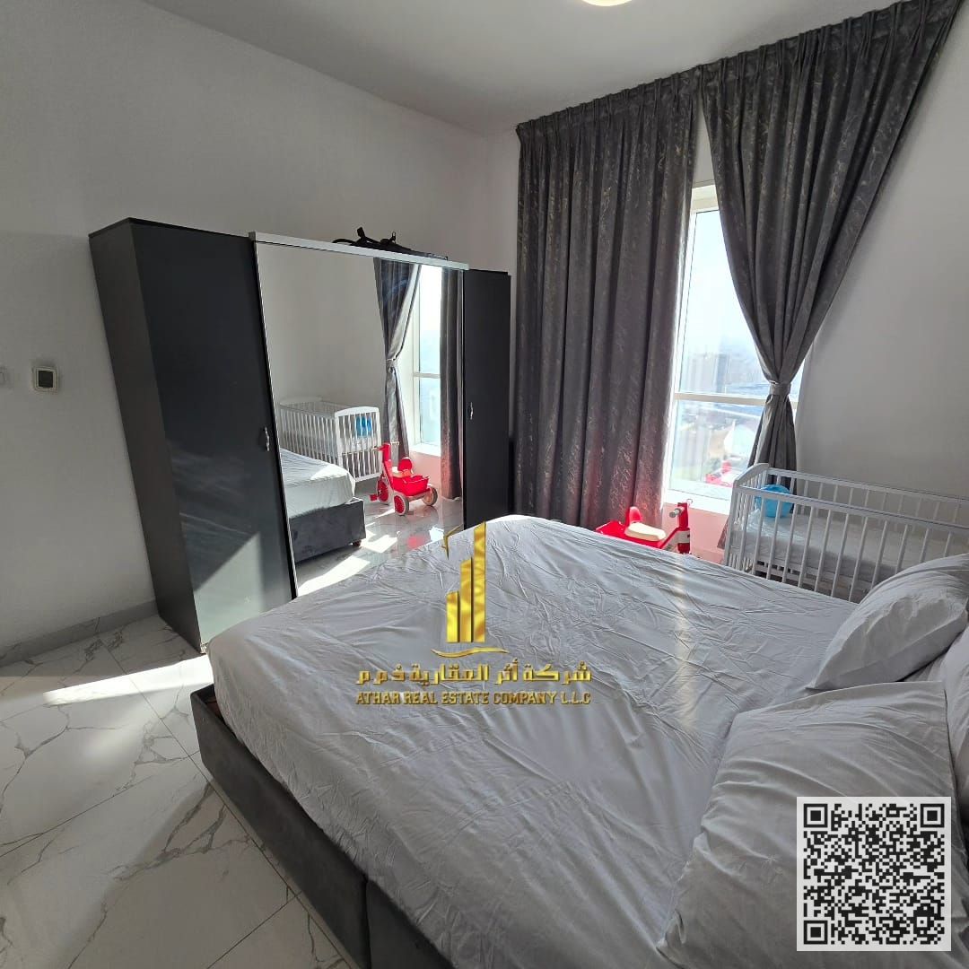 For monthly rent in Ajman - two-bedroom apartment with a balcony, a distinctive open view, fully furnished with elegant furniture, and a fully equippe
