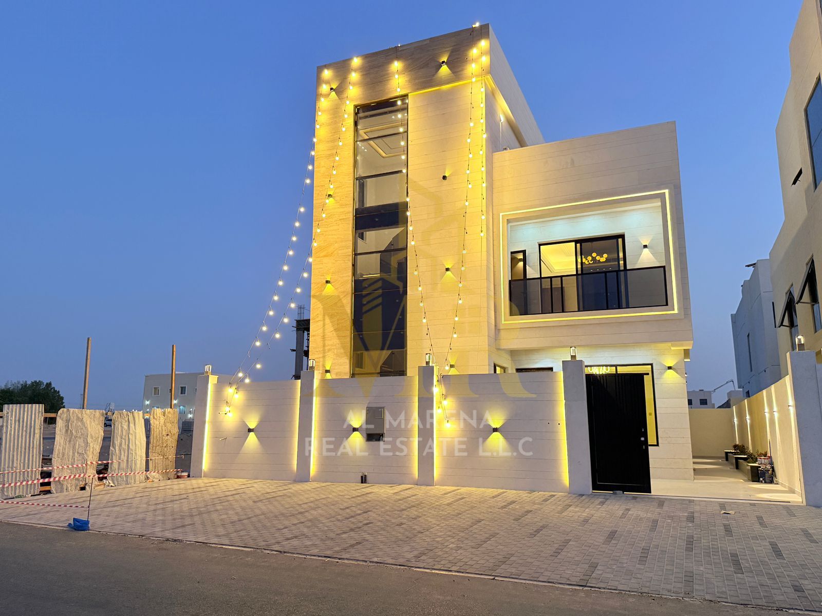 A luxurious, modern, 3-story villa in Al Helio, Ajman, on a main street with spacious areas and high-end finishes. The price includes registration and