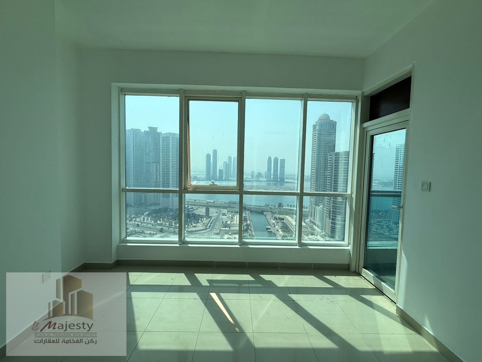 An apartment with a distinctive panoramic view of Al Mamzar Lake, the Qasba Canal, and the future Qasba Mall, located in Al Majaz 3, Sharjah.