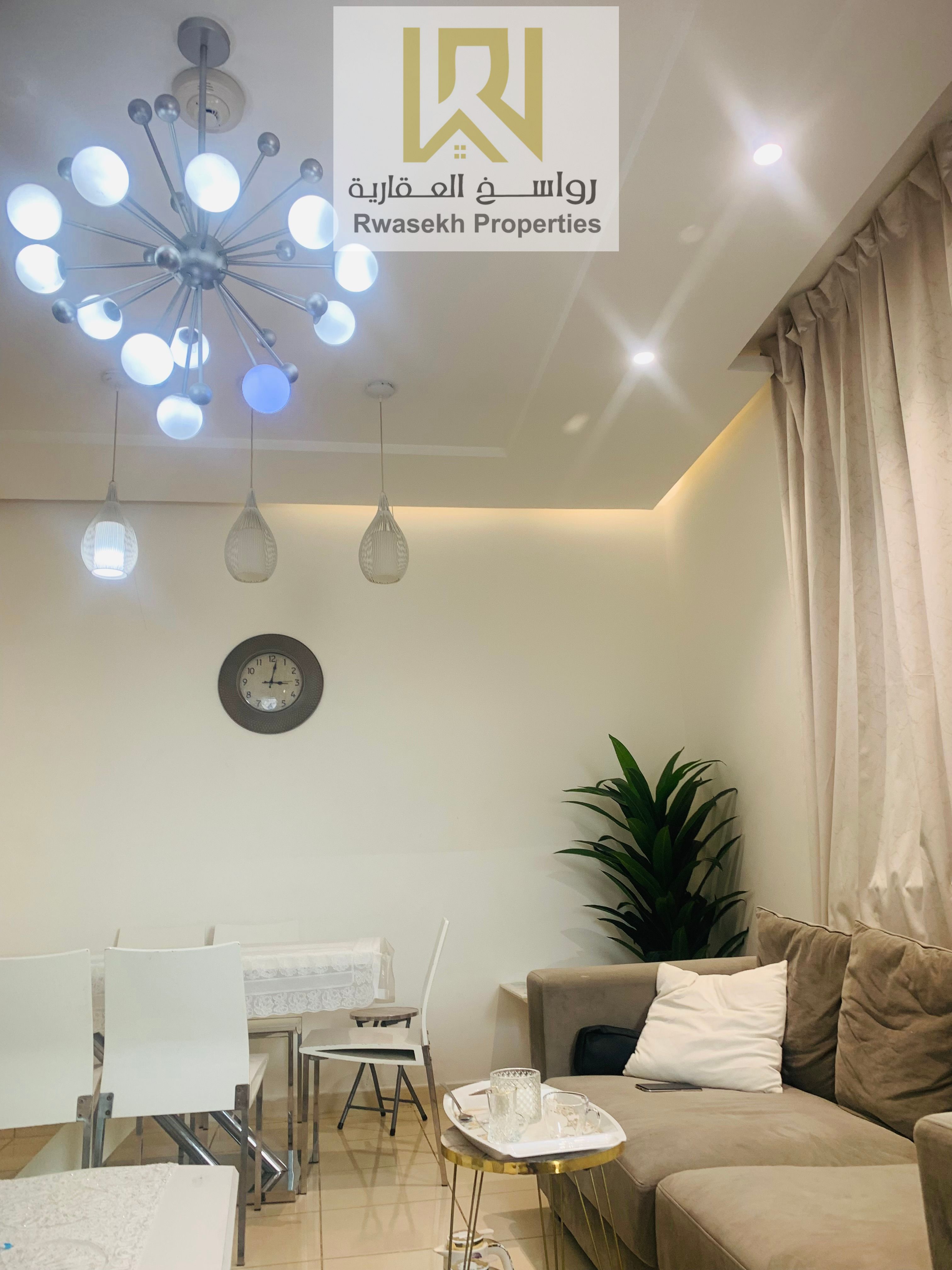 Real estate investment opportunity in Orient Towers, Ajman - 2 bedroom and hall apartment for sale with easy monthly installment plan.