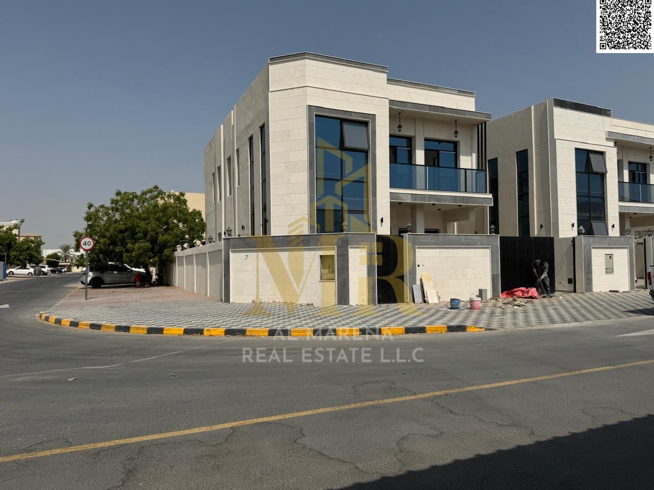 For sale in Ajman, a luxurious corner villa in Al Muwaihat 2. Located on Sheikh Ammar Street, the price is negotiable and includes electricity, water,