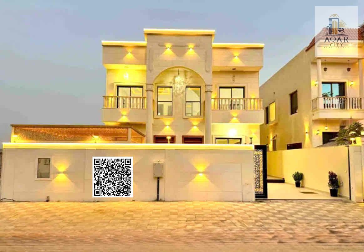 Classic villa for sale in Ajman, Al Zahia area. The villa is two floors, new, with electricity and air conditioning. It has five master bedrooms, two halls, a sitting room, a kitchen, a maid's room, and a courtyard with a sitting area. The land area is 4,
