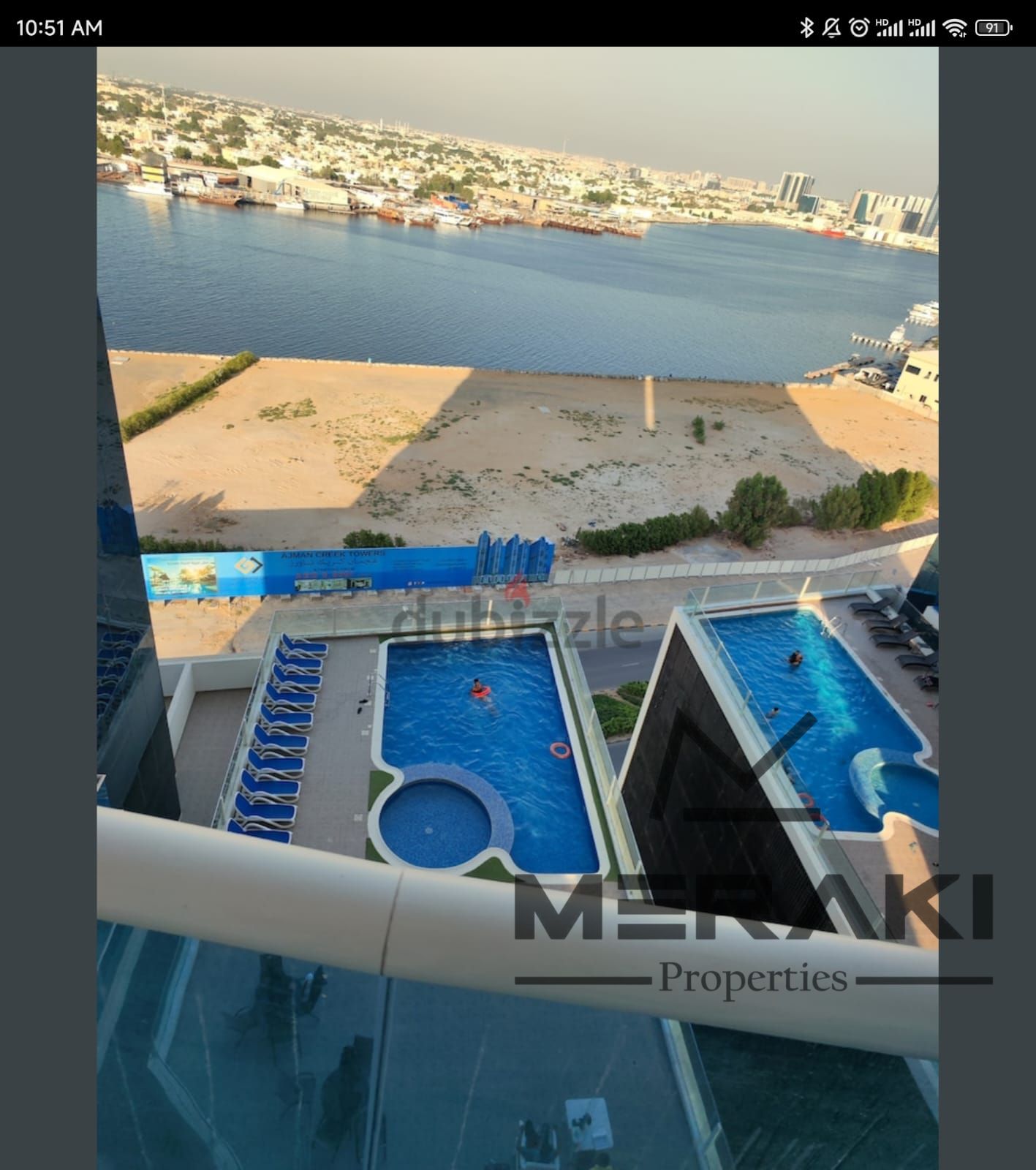 A one-bedroom apartment with a living room in Oasis Towers 2, featuring a great space and an amazing location in the heart of Ajman, good price.