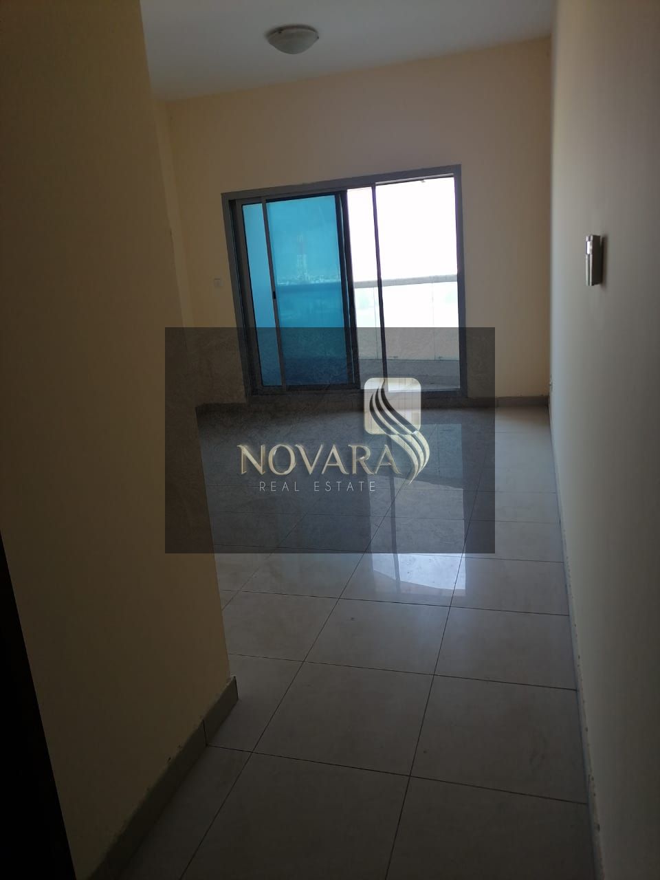 Apartment for rent in Ajman: one bedroom, living room, two bathrooms, and a balcony.