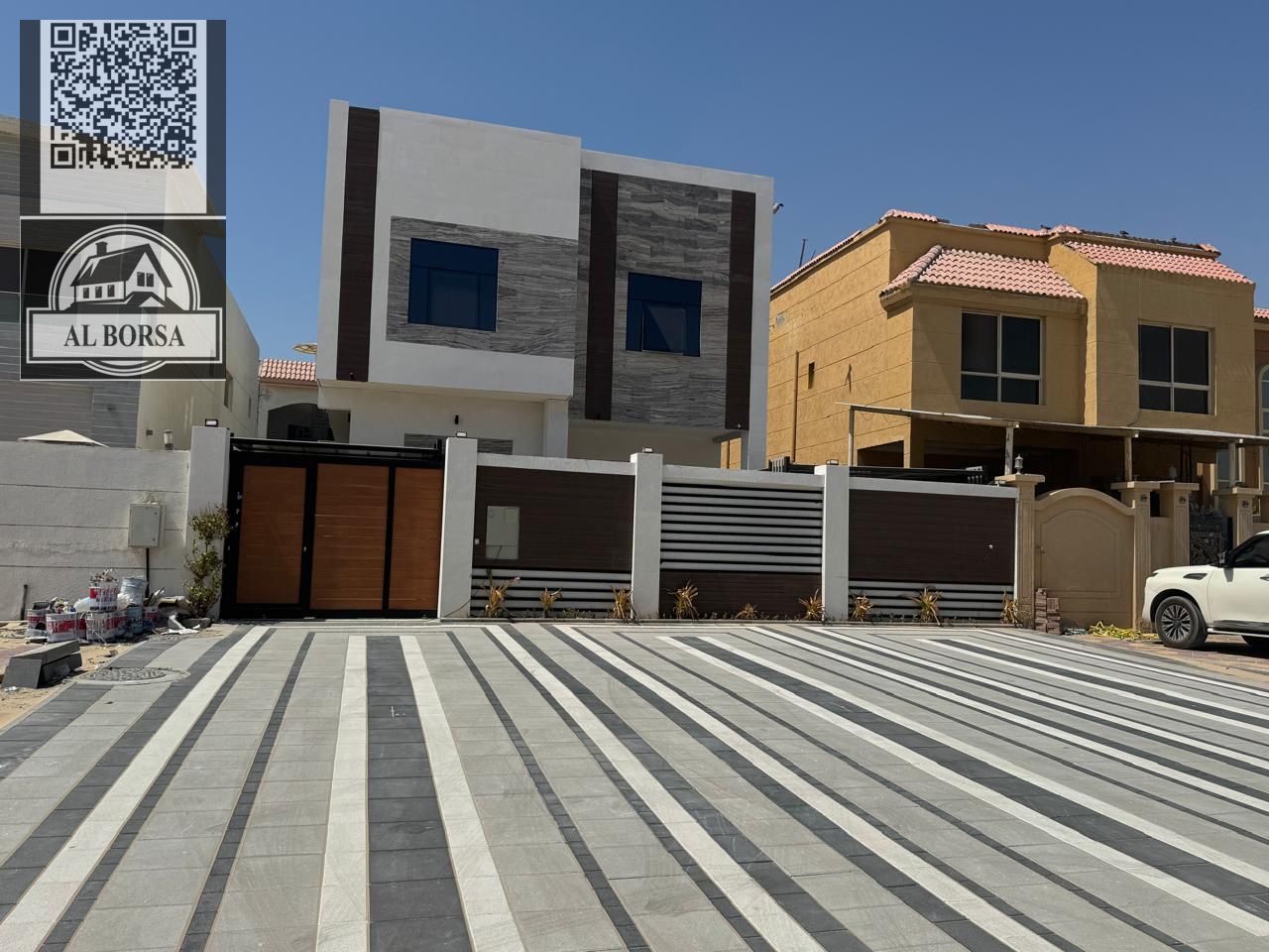 For sale: A five-bedroom villa with a master suite, separate majlis, living room, and an external annex with a kitchen and outdoor seating area in Al