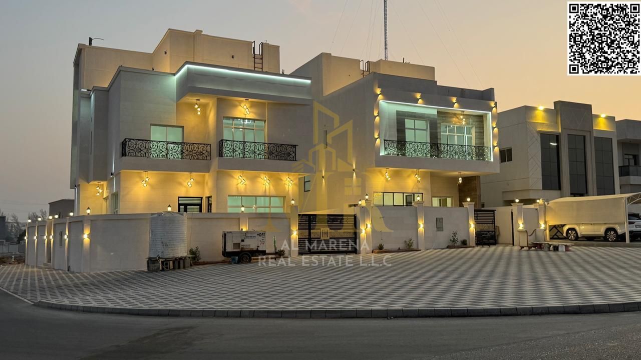 Luxury villa for sale in Al Helio 2 area – Ajman, corner plot on two streets, includes central air conditioning, freehold ownership for all nationalit