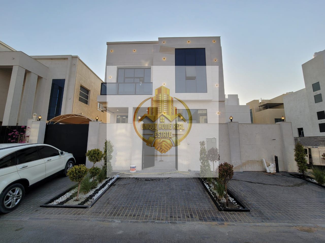 Modern villa for sale in Al-Yasmeen area, including registration fees. The villa is completely stone-faced, with a distinctive front setback, parking
