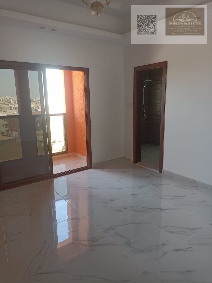 Upscale 2-bedroom apartment with a living room – first occupancy – in Al Muwaihat 3 | Exceptional location and brand new building