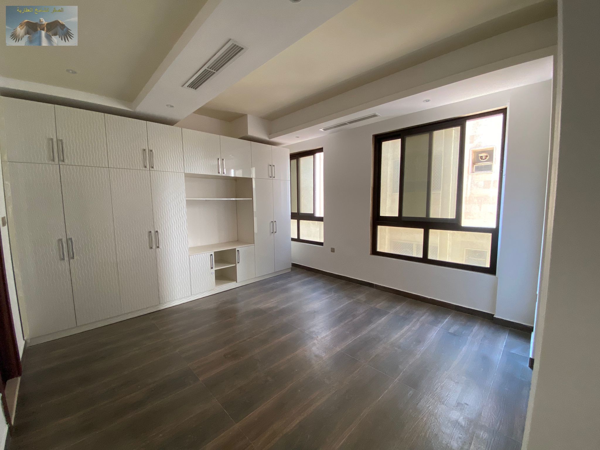 Spacious two-bedroom apartment with built-in wardrobes and three bathrooms, featuring super deluxe finishes, near the Dubai and Sharjah exit.