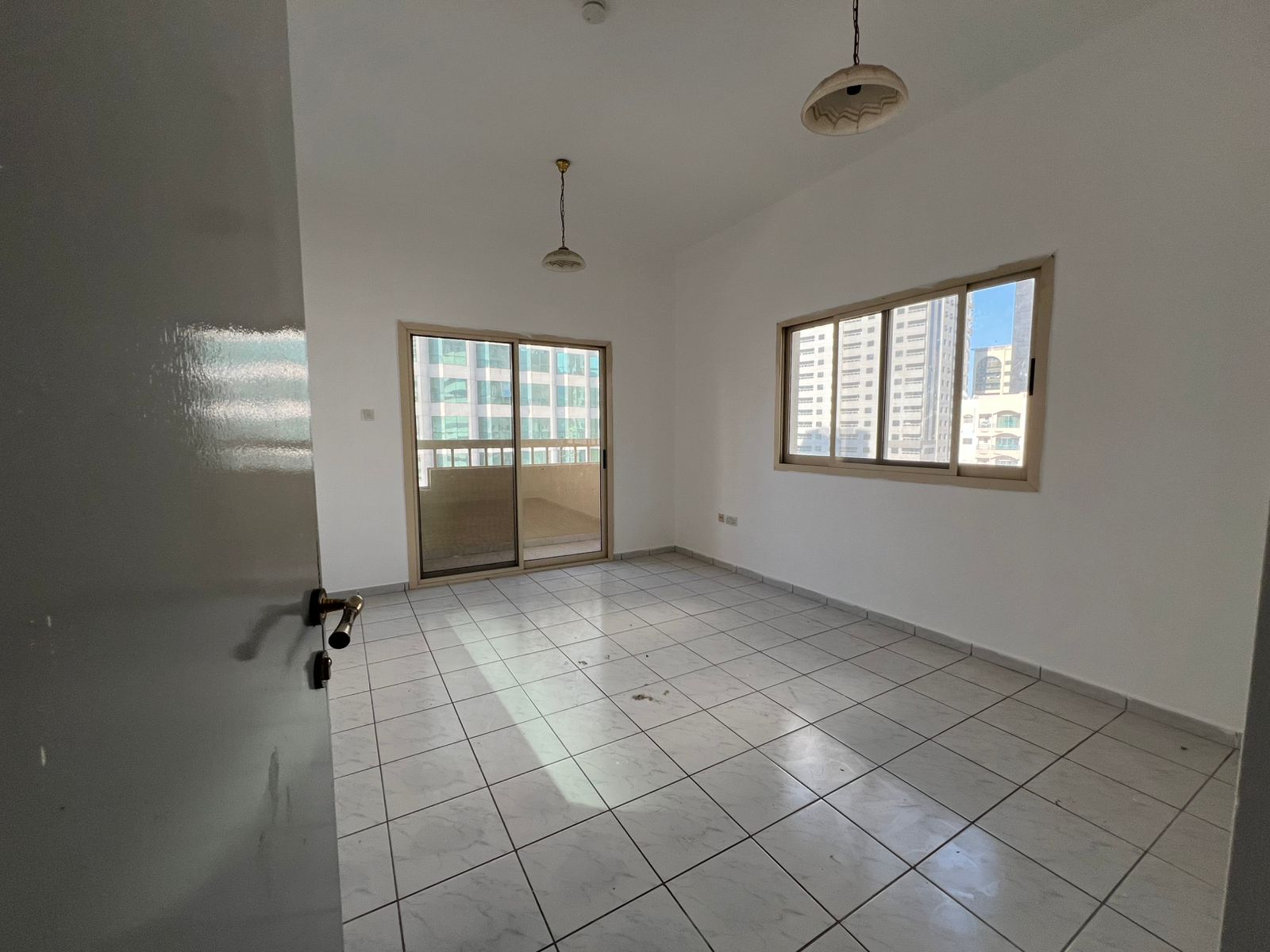 2BR apartment in Al Majaz 3 with balcony, great view, free AC, spacious layout, and two bathrooms. Rent is 48,000 with more options available.