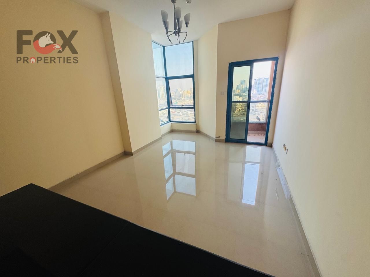 Large studio for rent, first occupancy, spacious, prime location with open view of Al-Hikma School, easy access to Sharjah and Dubai, includes parking