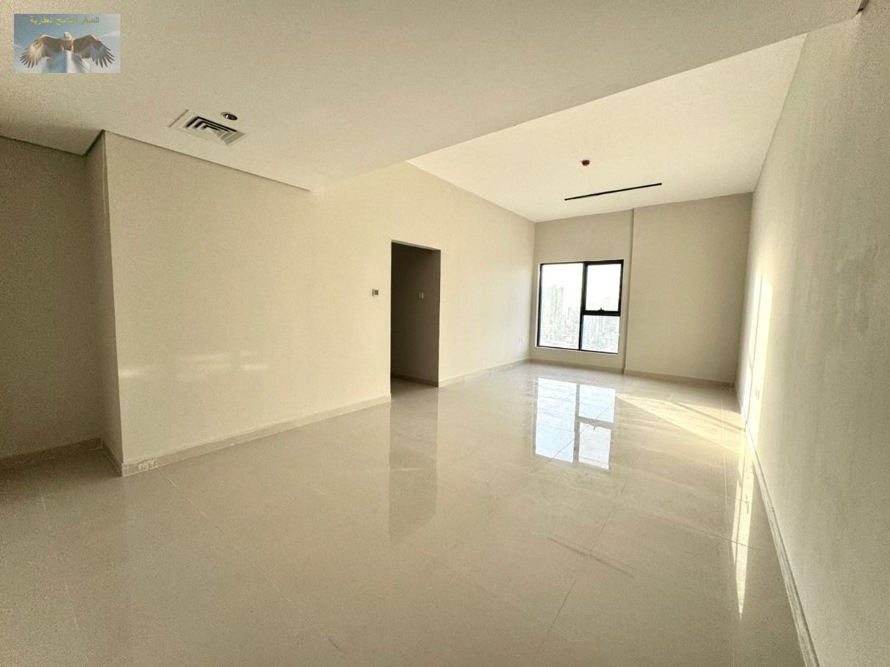 For rent in Ajman, a brand new two-bedroom apartment with a living room.