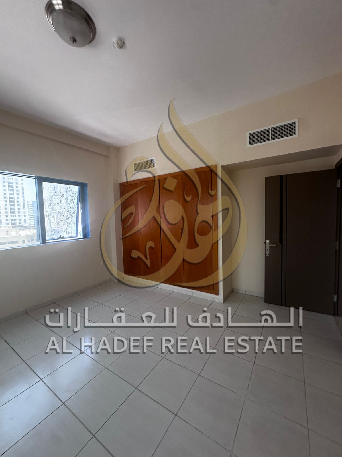 Sharjah Emirate, Al Rolla area, a two-bedroom apartment with a large living room is available, with a wall closet, two bathrooms, and a balcony, in ad
