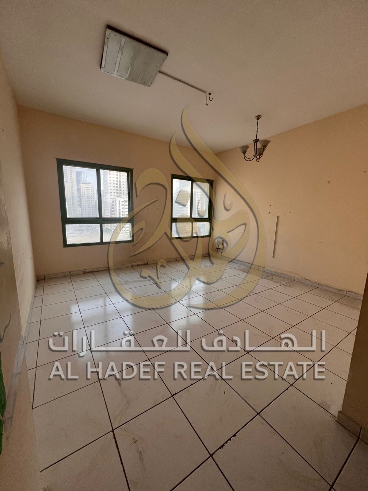 Two-bedroom apartment with a living room, storage room, and built-in wardrobes, near Al Nahda Park.
