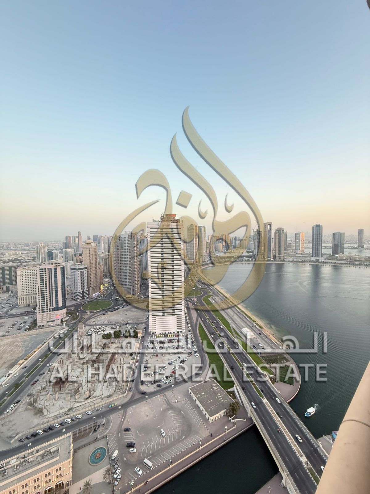 For Rent in Sharjah, Al Qasba: Spacious 2-bedroom apartment with a balcony and full sea view, large kitchen, and 3 bathrooms. Includes free gym and sw