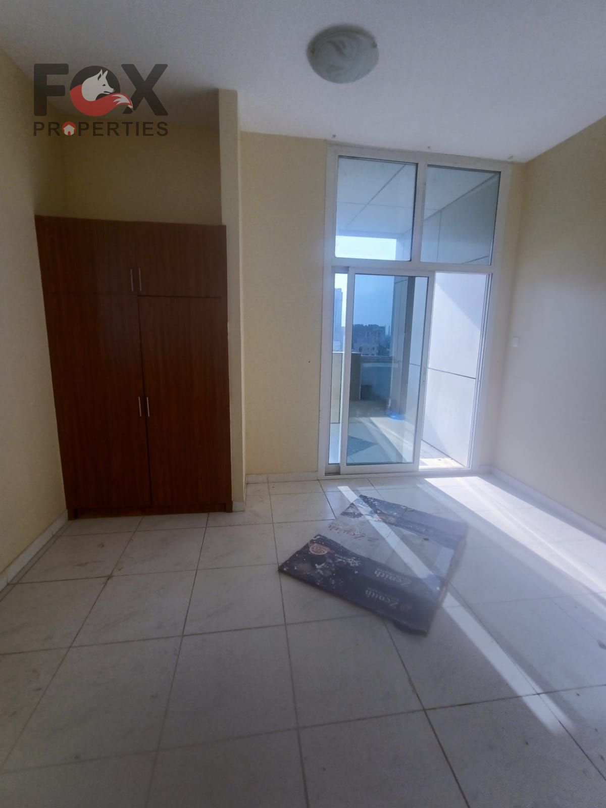 Two bedrooms and a living room for rent in Al Rashidiya 3, next to Grand Mall, with a balcony and a prime location close to all services.