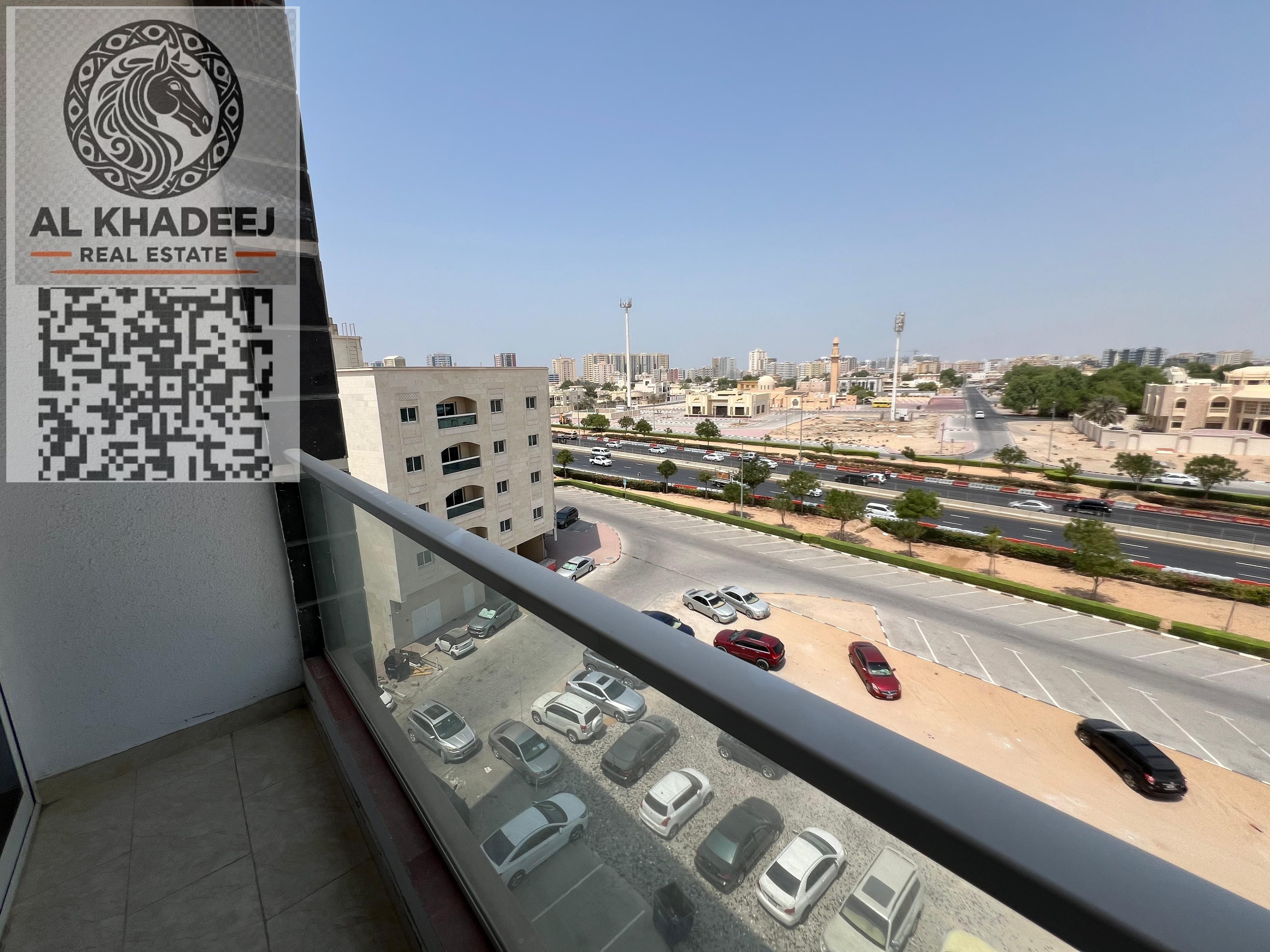 Two rooms and a hall with a large area and a balcony with an open view with a month and free parking in Rawda 2, easy access to Dubai and Sharjah