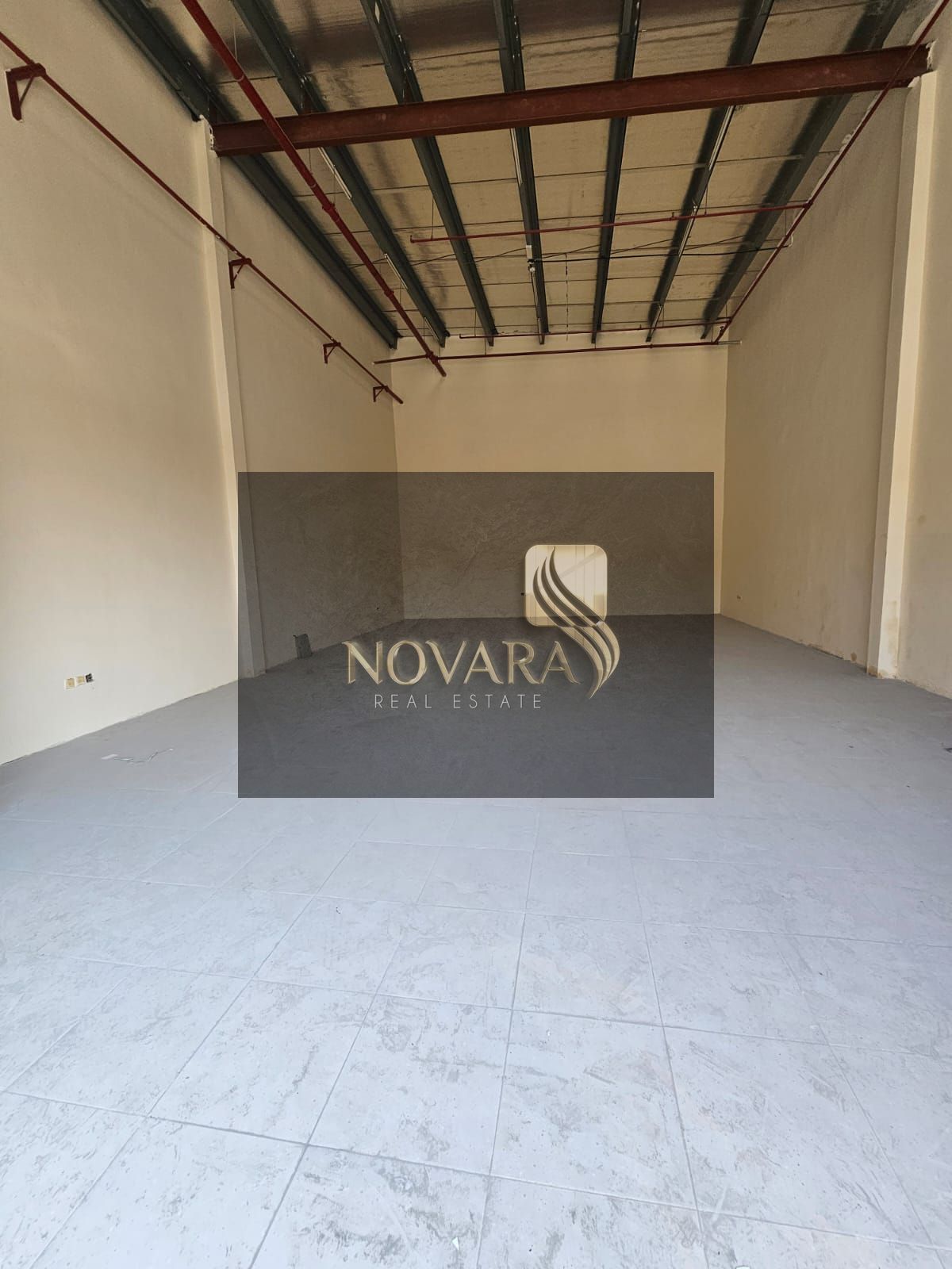 Annual rent: 1850 sq ft warehouse in Al Jurf Industrial Area 1, 25 kW electricity, on a main street, for 95,000