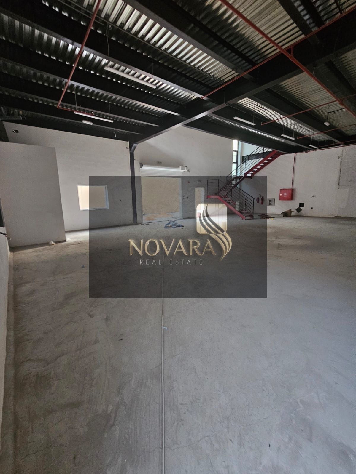 3600 sq ft warehouse with two mezzanines in Al Jurf Industrial Area 1, 50KW electricity and two internal bathrooms, for annual rent at a price of 187,