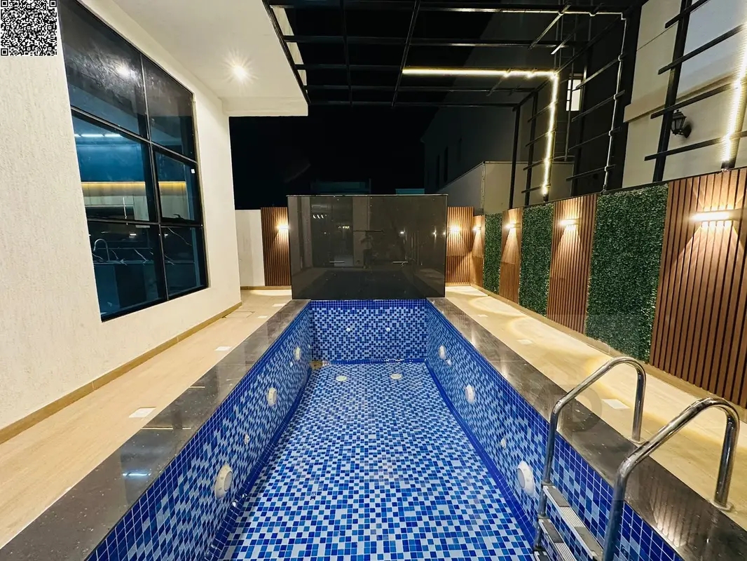 For sale: Two-story villa with a rooftop terrace and an indoor swimming pool, one of the most luxurious villas in Ajman, near Mohammed Bin Zayed Road.
