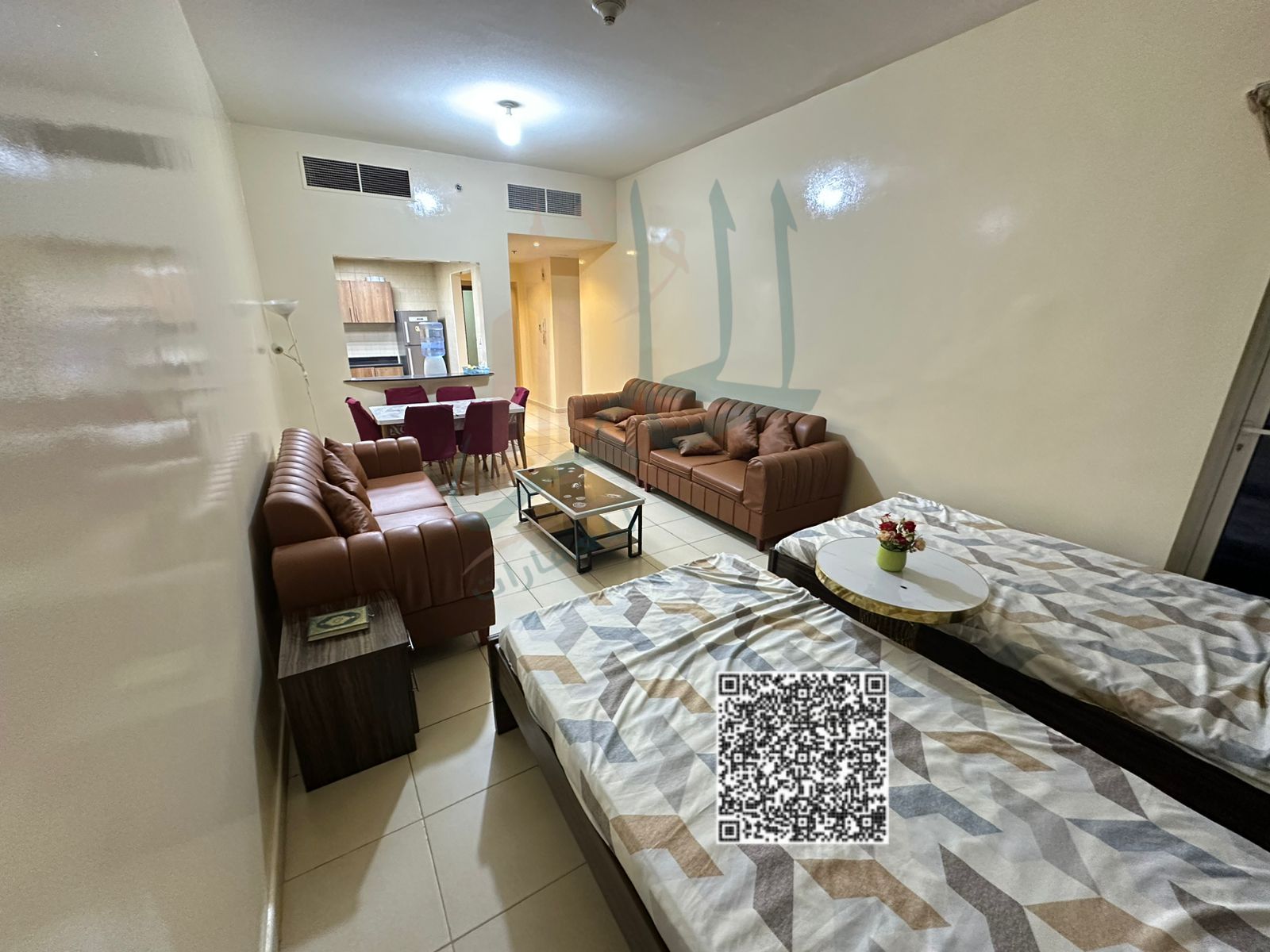 A two-bedroom apartment for sale in Ajman One Tower with a view of the city and the park, along with a gym and separate swimming pools for men and wom