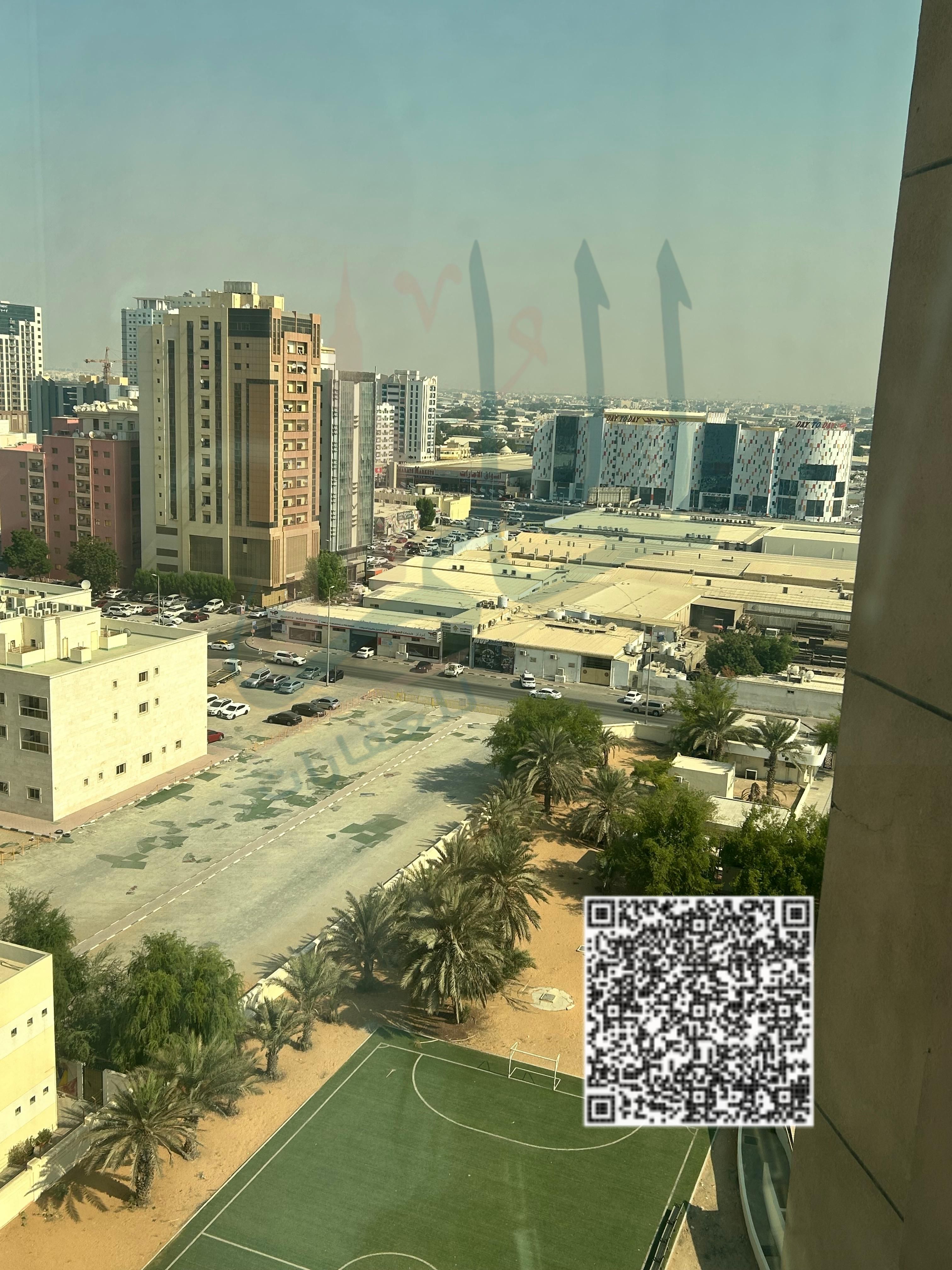 Two-bedroom apartment with a living room for sale in Al Nuaimiya Tower C, with an open view of Al Hikma School and Black Ramada Hotel. First installme