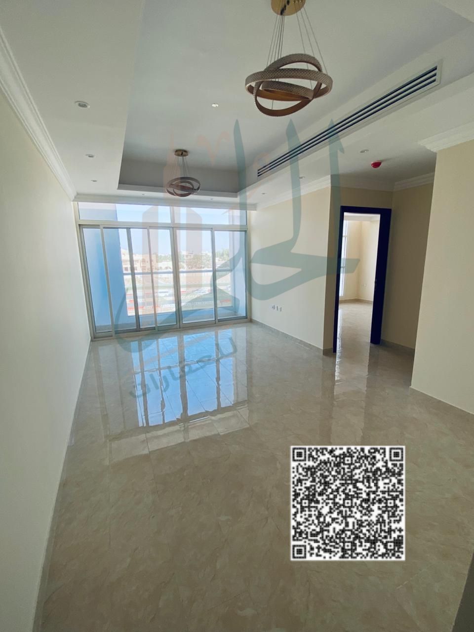 Two bedrooms and a living room for annual rent in a new building first occupancy with open view and a large balcony, opposite Kenz Mall on Sheikh