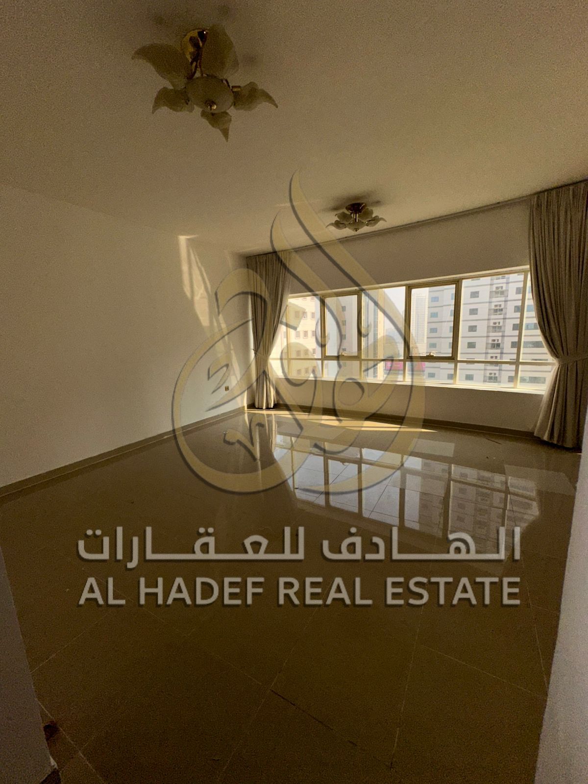 For annual rent in Sharjah, Al Taawun area: a 3-bedroom apartment with a living room, free air conditioning, free parking, gym, and swimming pool. Fle