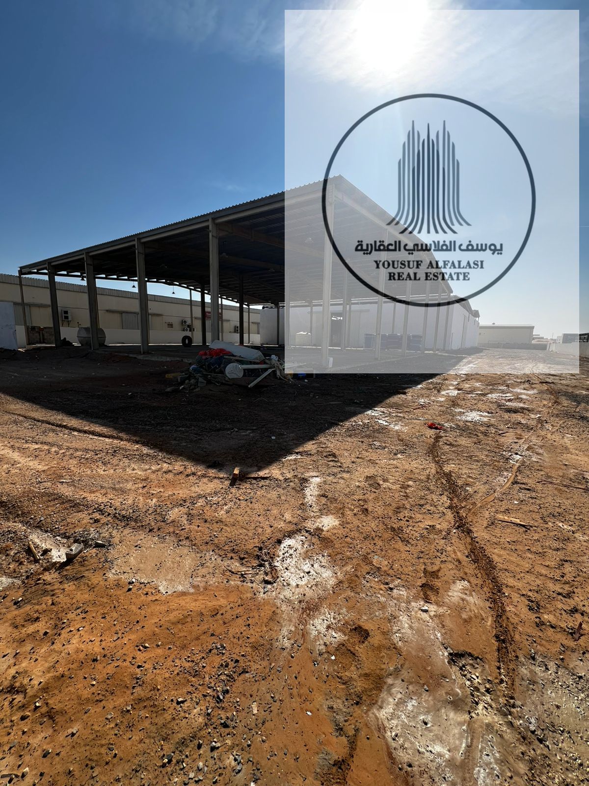 For rent in Umm Al Quwain - a 22,000 sq ft plot with 5,000 sq ft of two sheds and 110 kW electricity, price 450,000 dirhams per year.