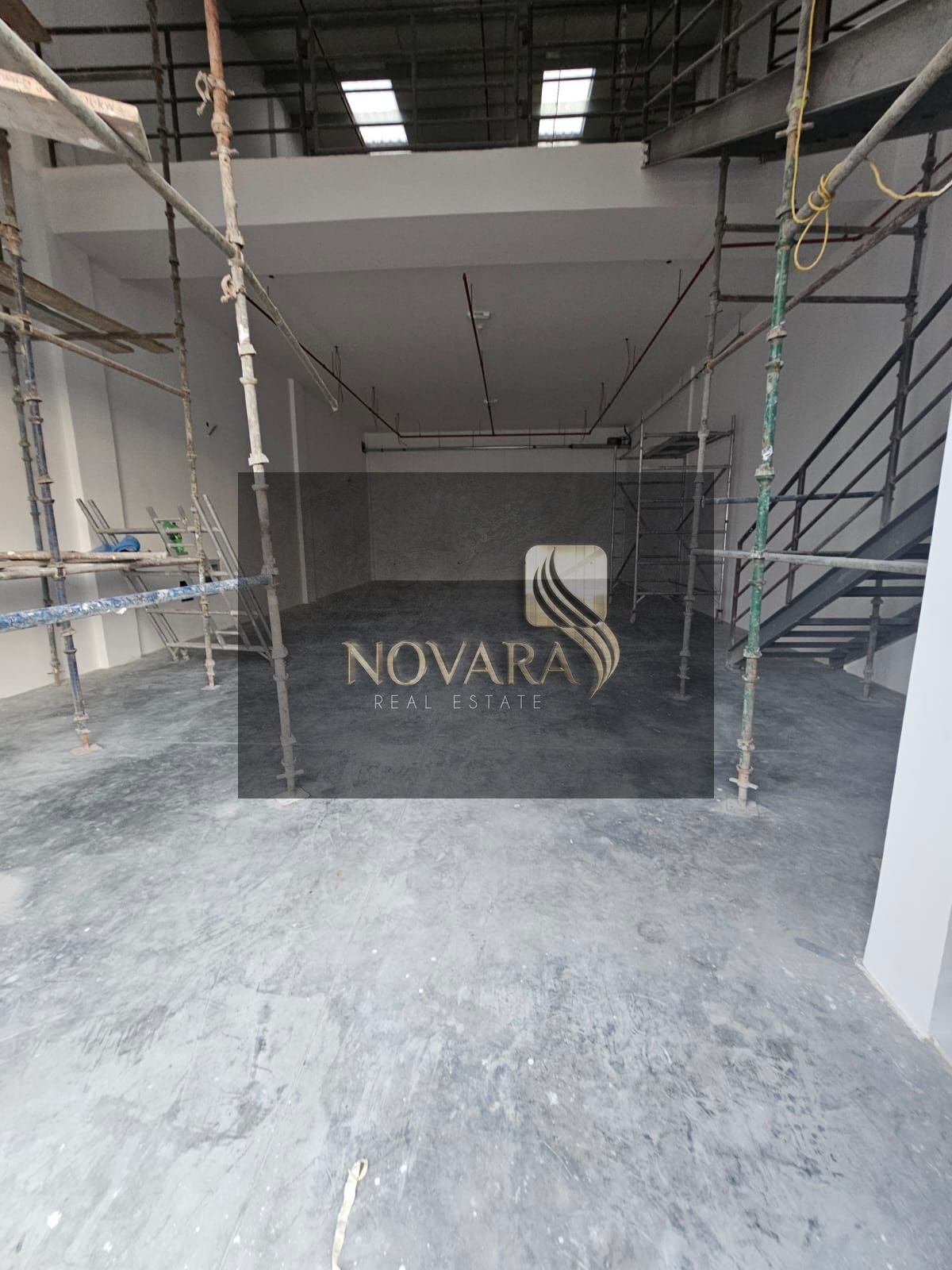 Warehouse complex in Ajman Al Jurf 3, 3000 sqft mezzanine, 62 kVA power, 12m height, dual road access, annual rent AED 175k.