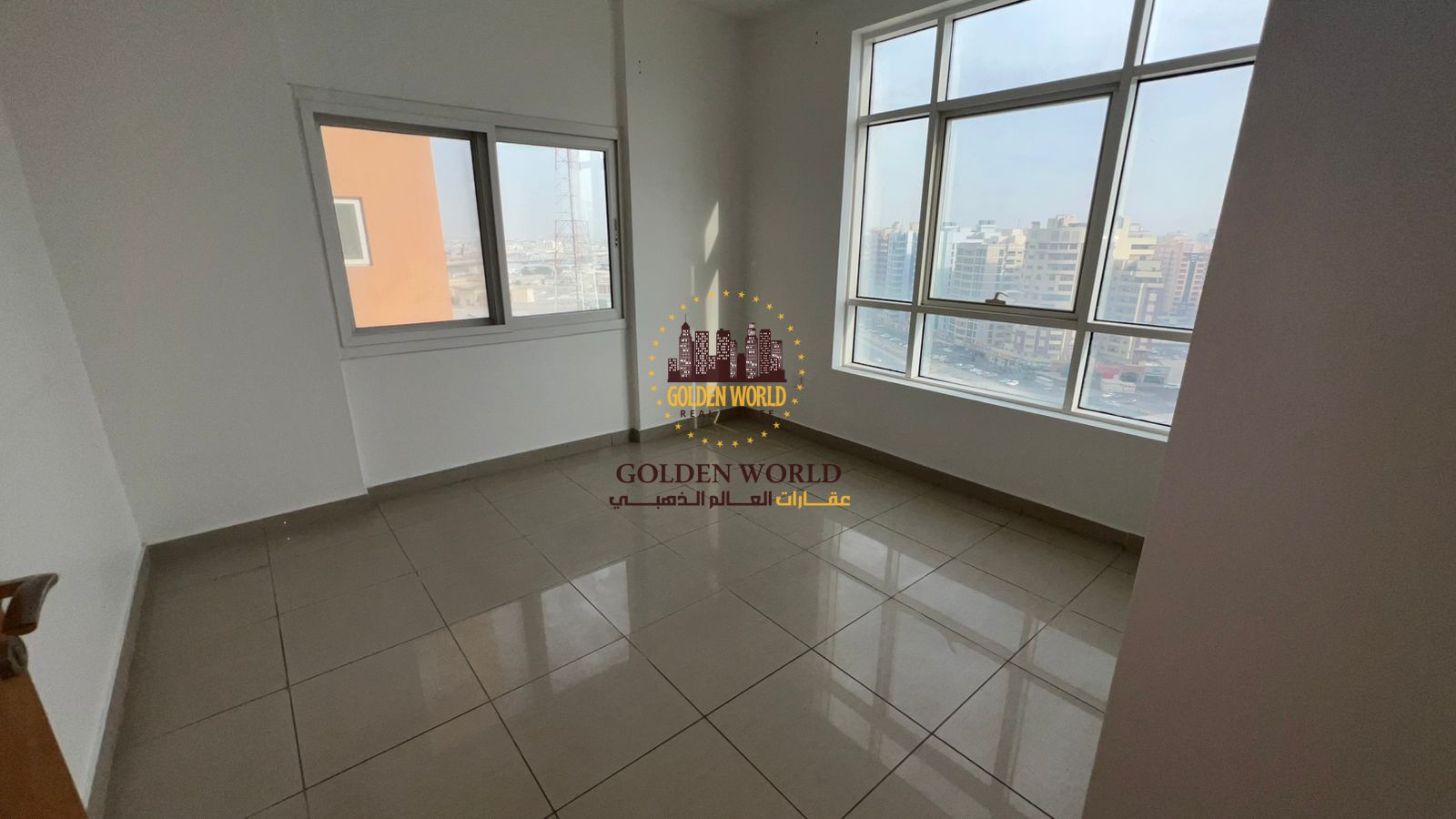 Two-bedroom apartment with a spacious living room for rent in Al Nahda, Sharjah, featuring a panoramic direct view of Dubai, a large balcony, built-in