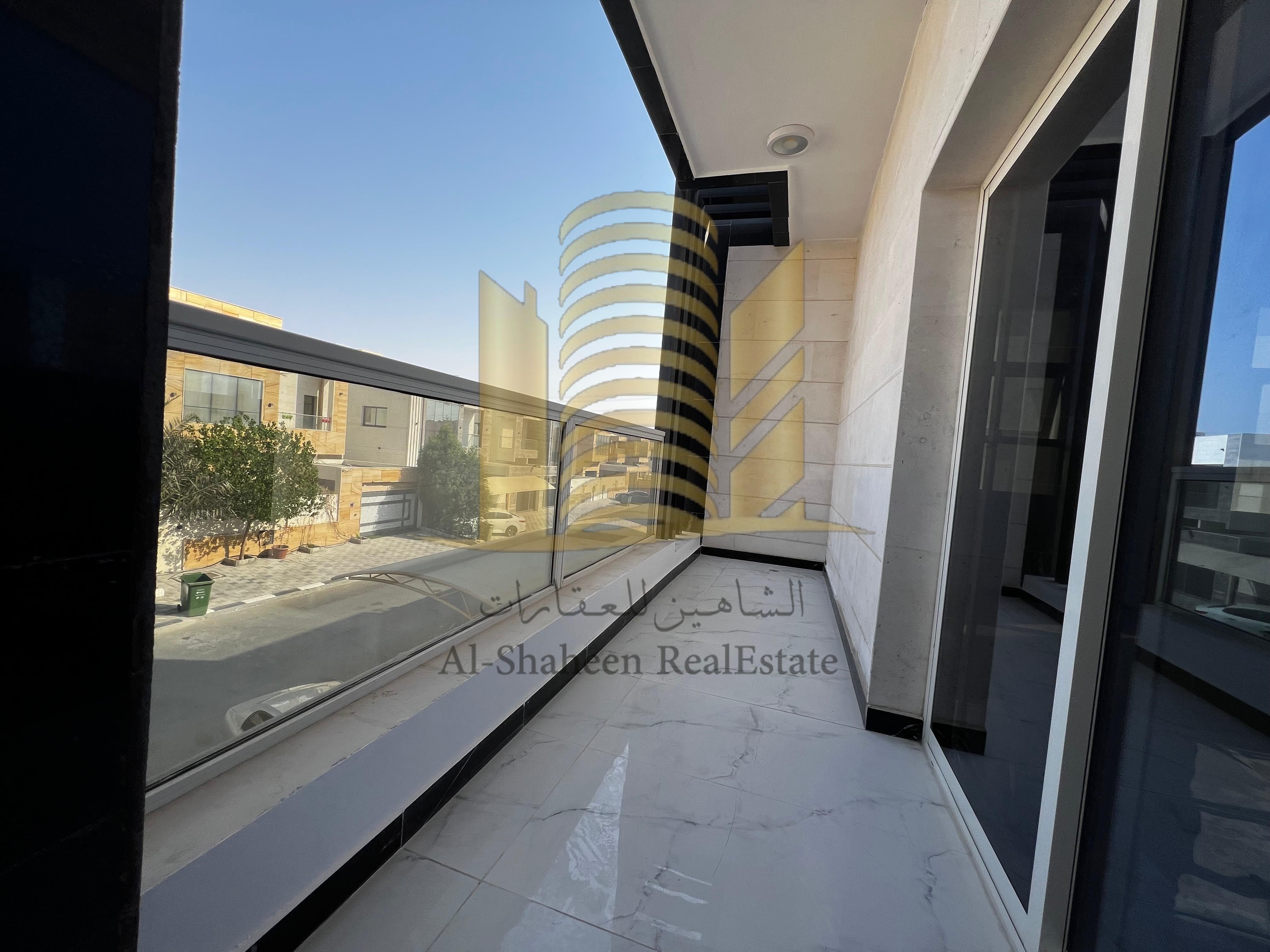 Villa for rent in Ajman, Al Yasmin area. It consists of 5 master bedrooms, a majlis (formal sitting room), a living room with washrooms, a yard, and new air conditioning units. The villa features high-end finishes. It boasts spacious areas, master bedroom