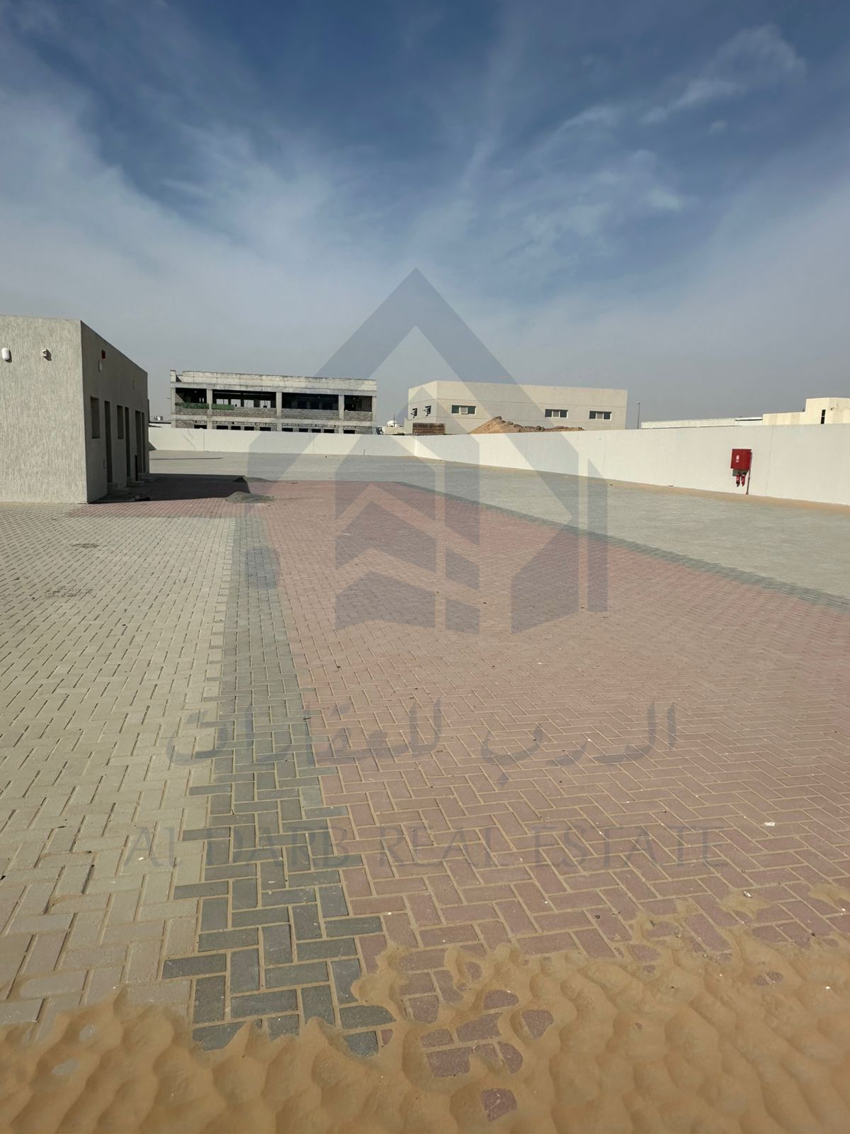 For rent in Al Sajaa area, a large fenced plot of land on the main road