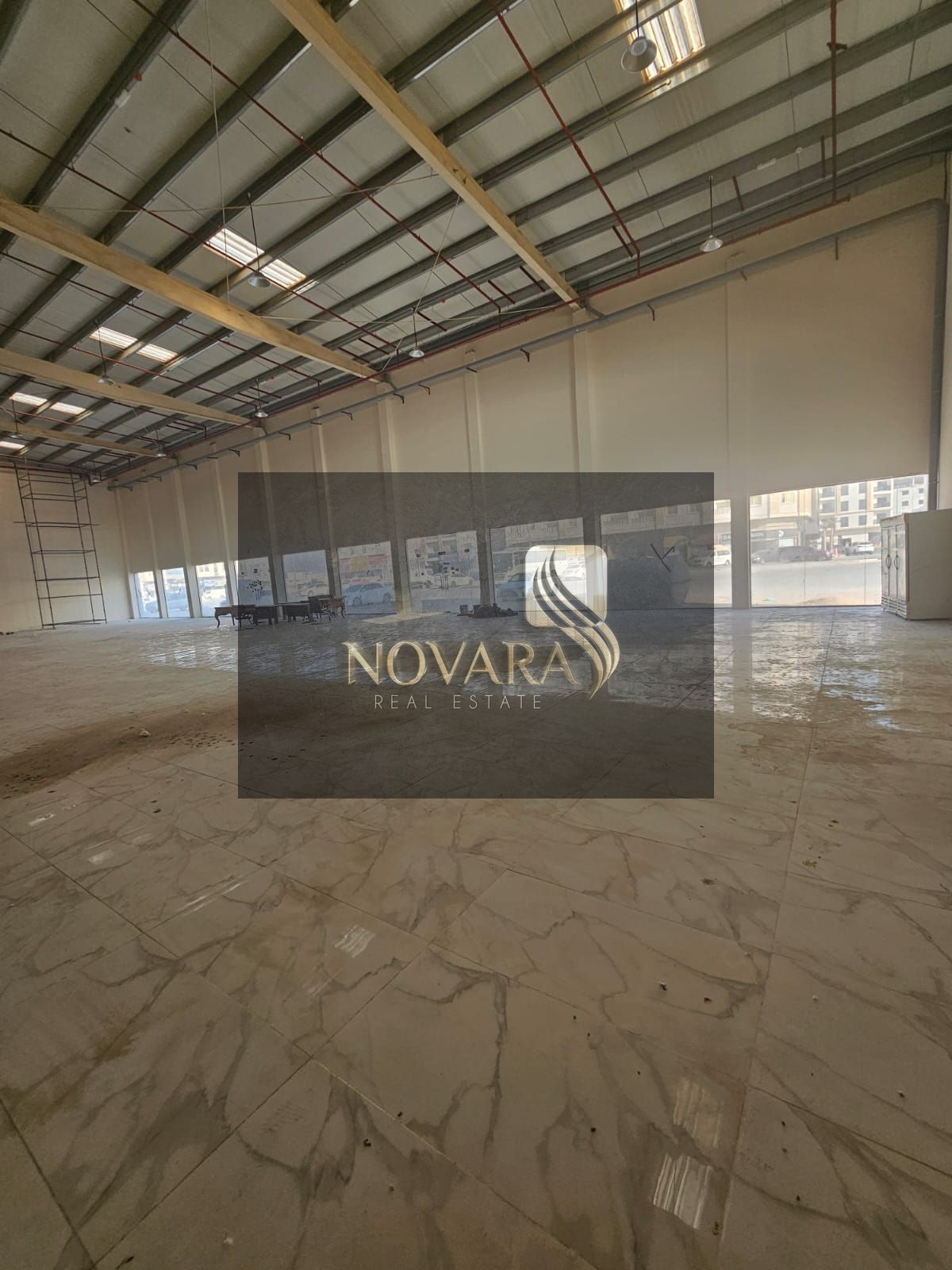Showroom for rent in Al Jurf Industrial 3 on a main road, 31,000 sq ft with mezzanine, 100 kW power, ideal business location.