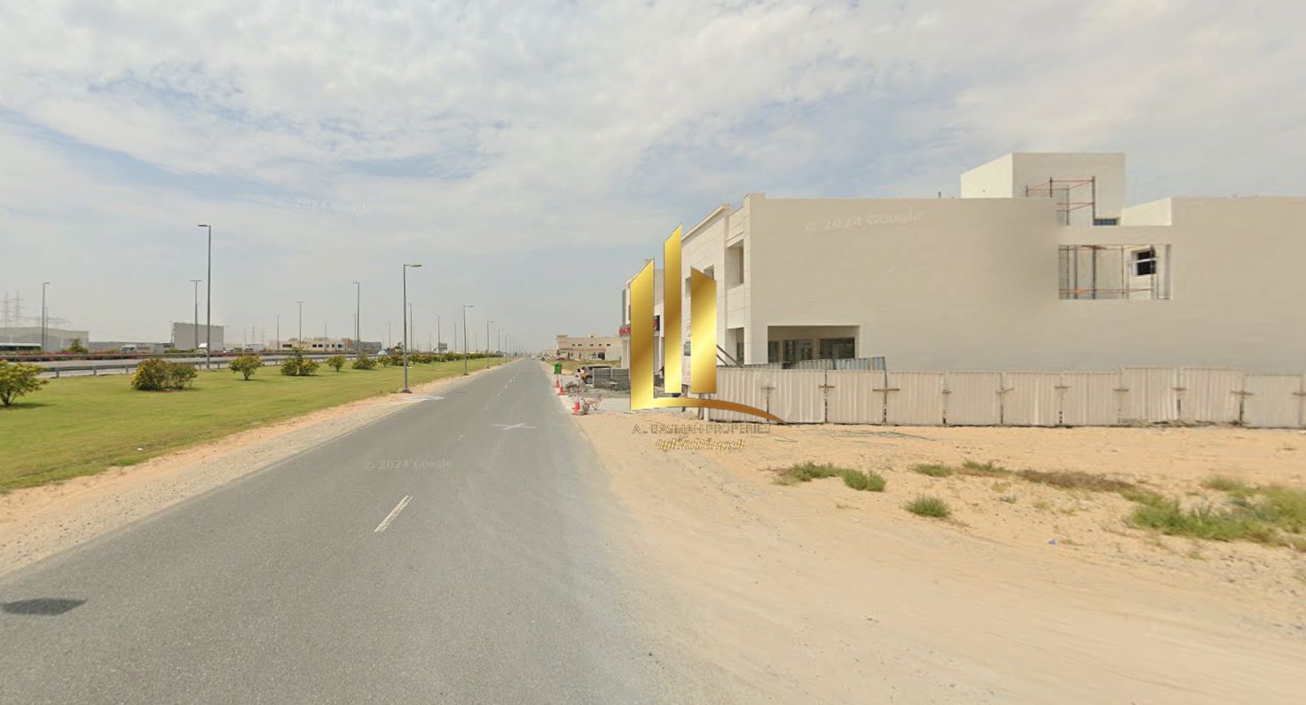 Commercial corner plot for sale in Al-Hawshi, directly on Maliha Street - Sharjah