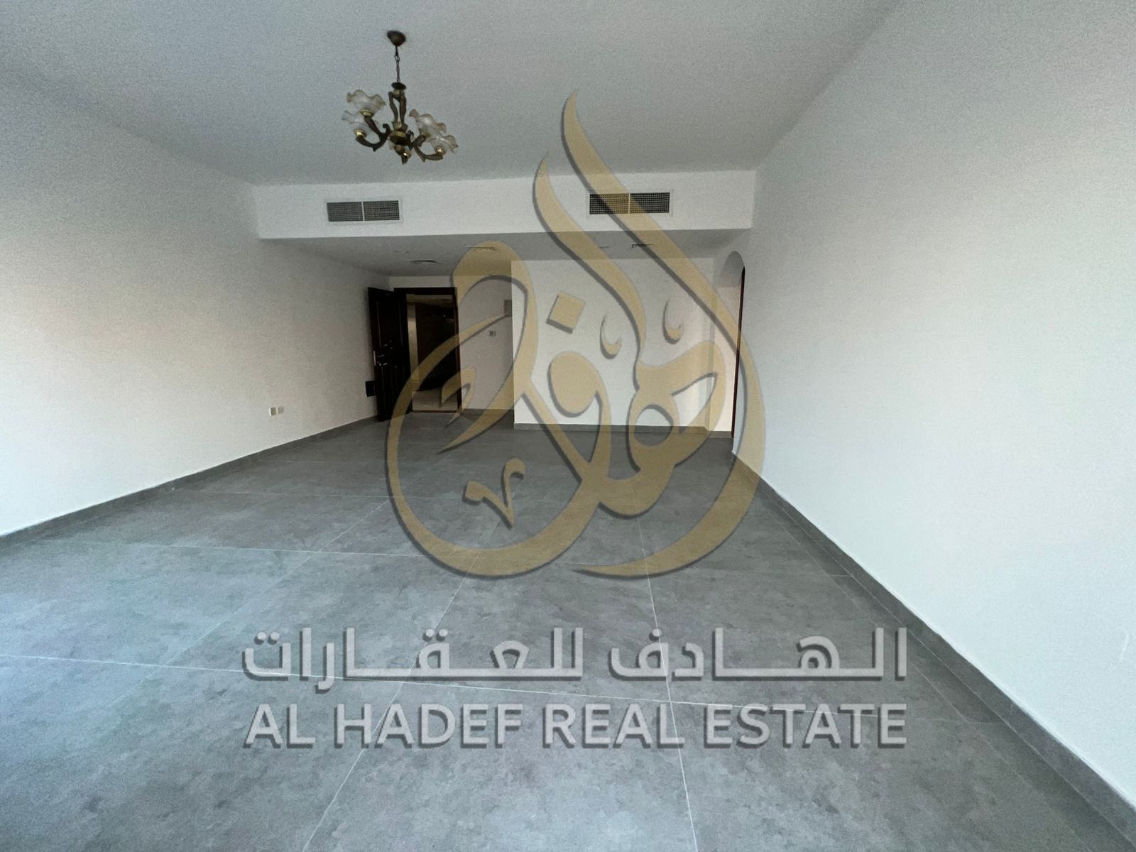 In the Al Wahda Street area, a two-bedroom apartment with a living room and open views is available, featuring air conditioning, free gym access, and