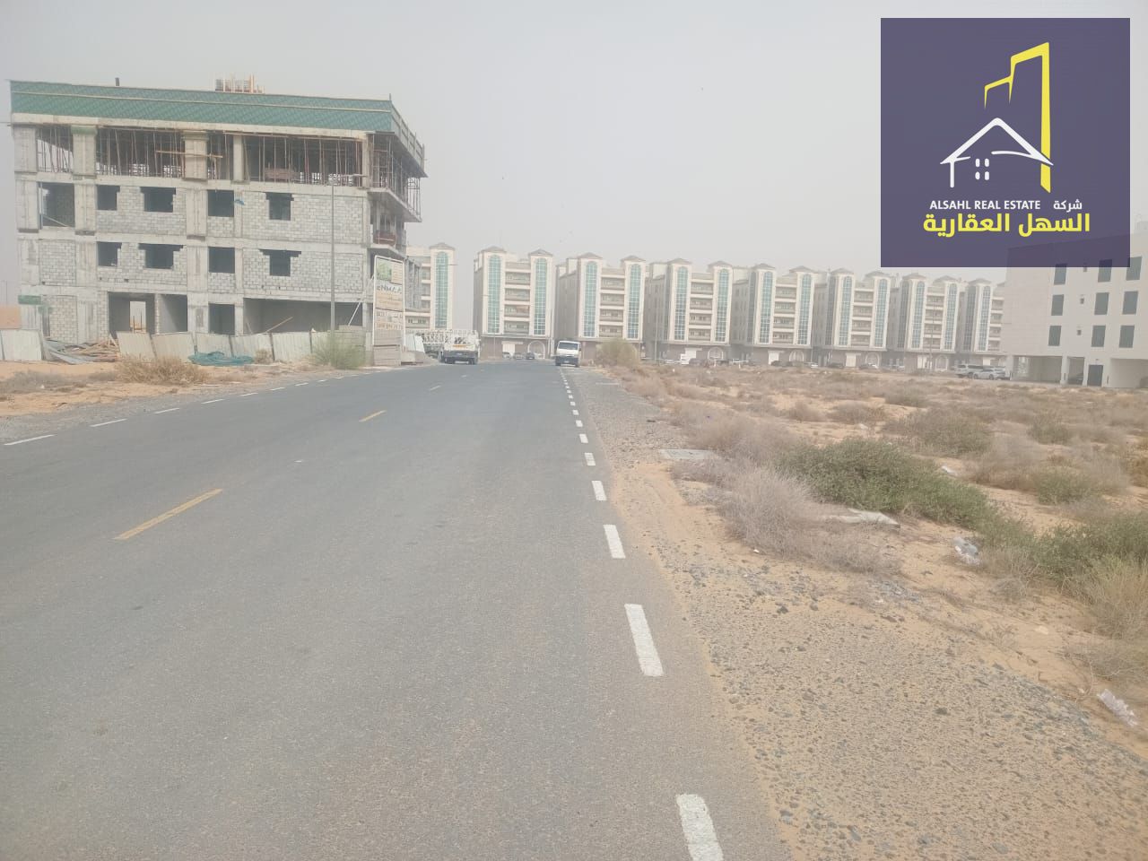 For sale: a residential–commercial plot located in Tilal Area – Sharjah (Al Suyoh Suburb), featuring an excellent corner location overlooking an 18-me