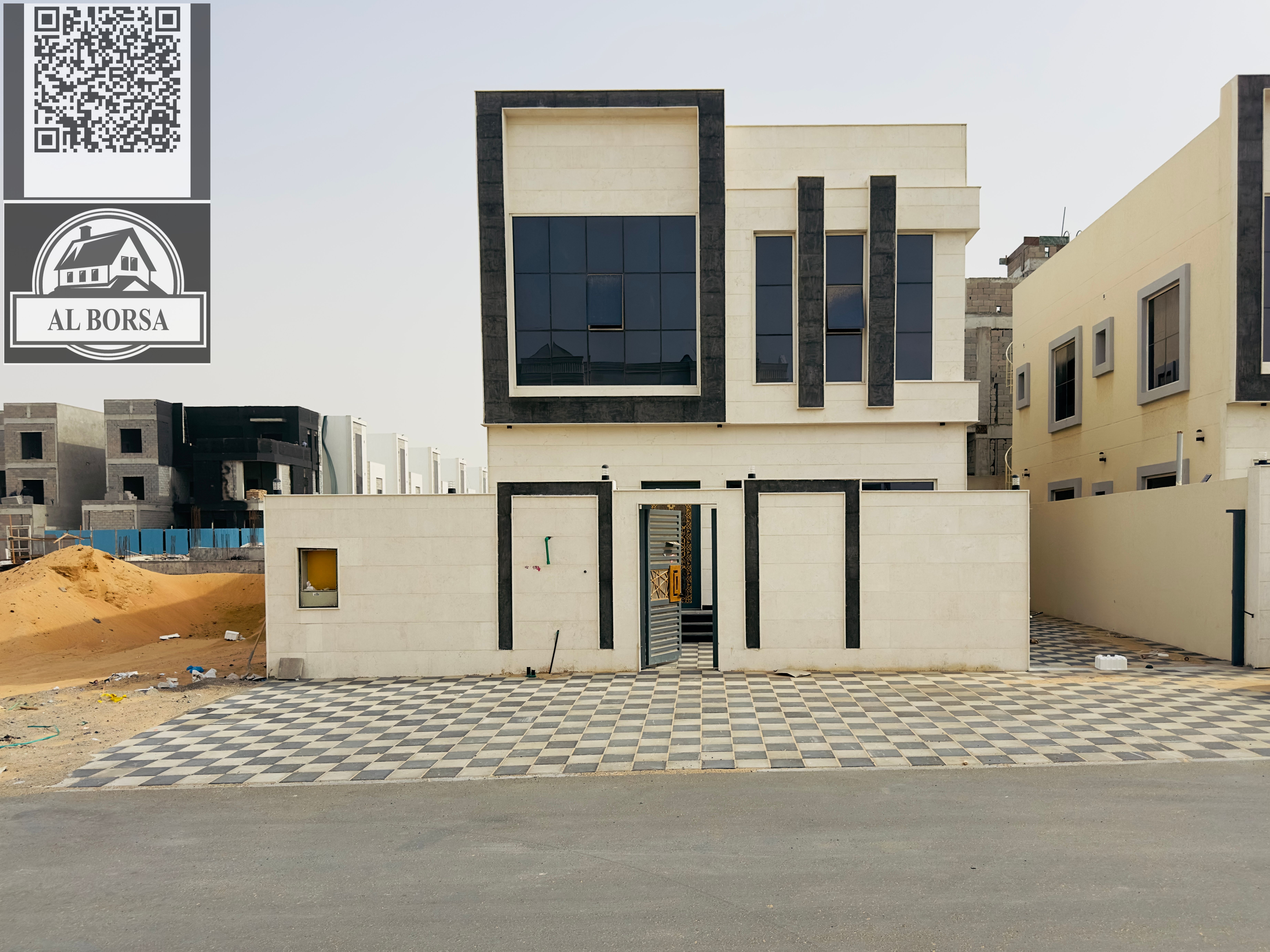 For SALE a villa in Al Helio 2 in Ajman, 5 master bedrooms, a majlis, a hall, a maid's room, and a store