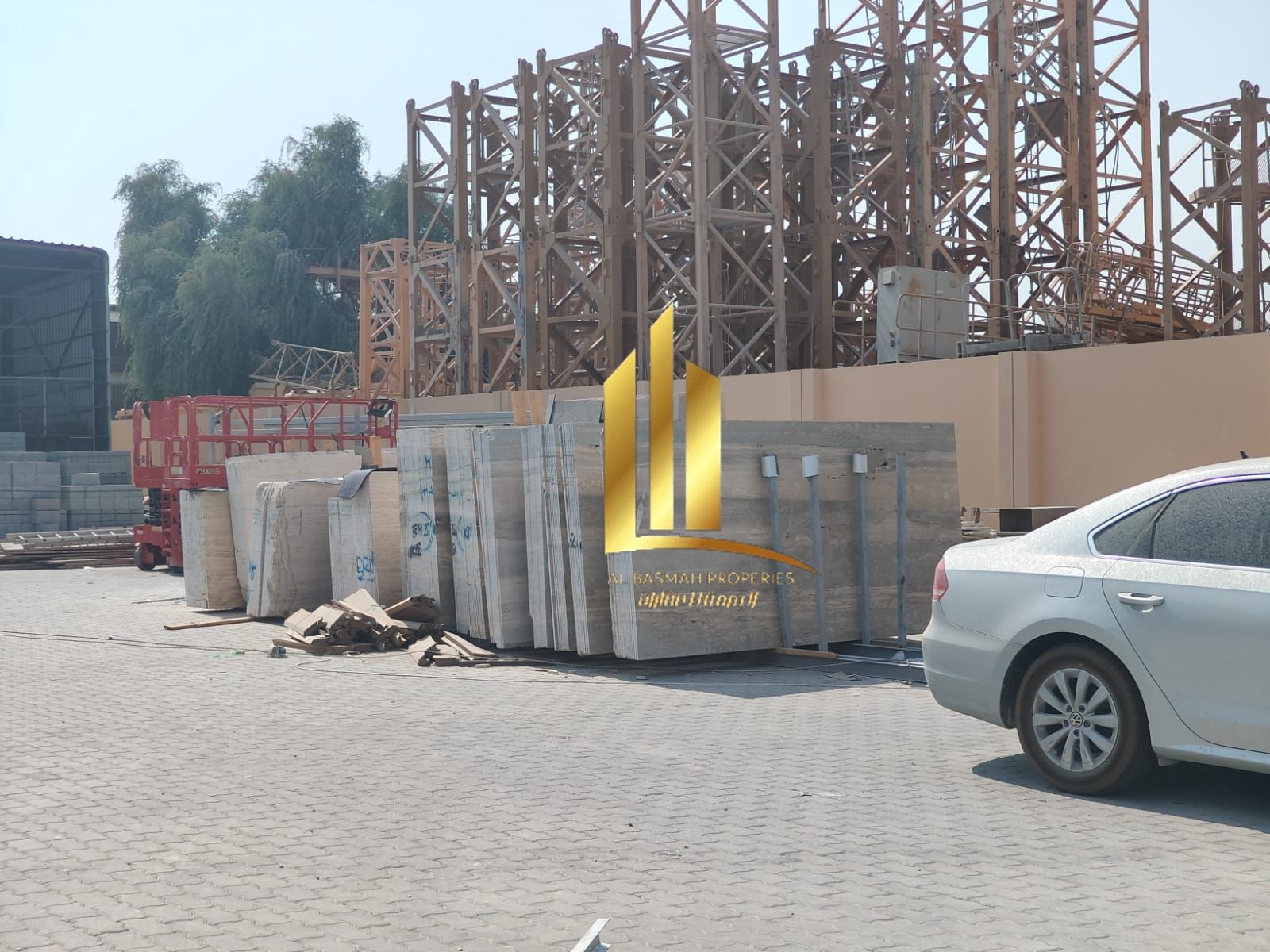 For Sale: A plot of land in Sharjah, Al Sajaa Industrial Area, measuring 18,665 square meters. It is located on a 24-meter wide street and includes tw