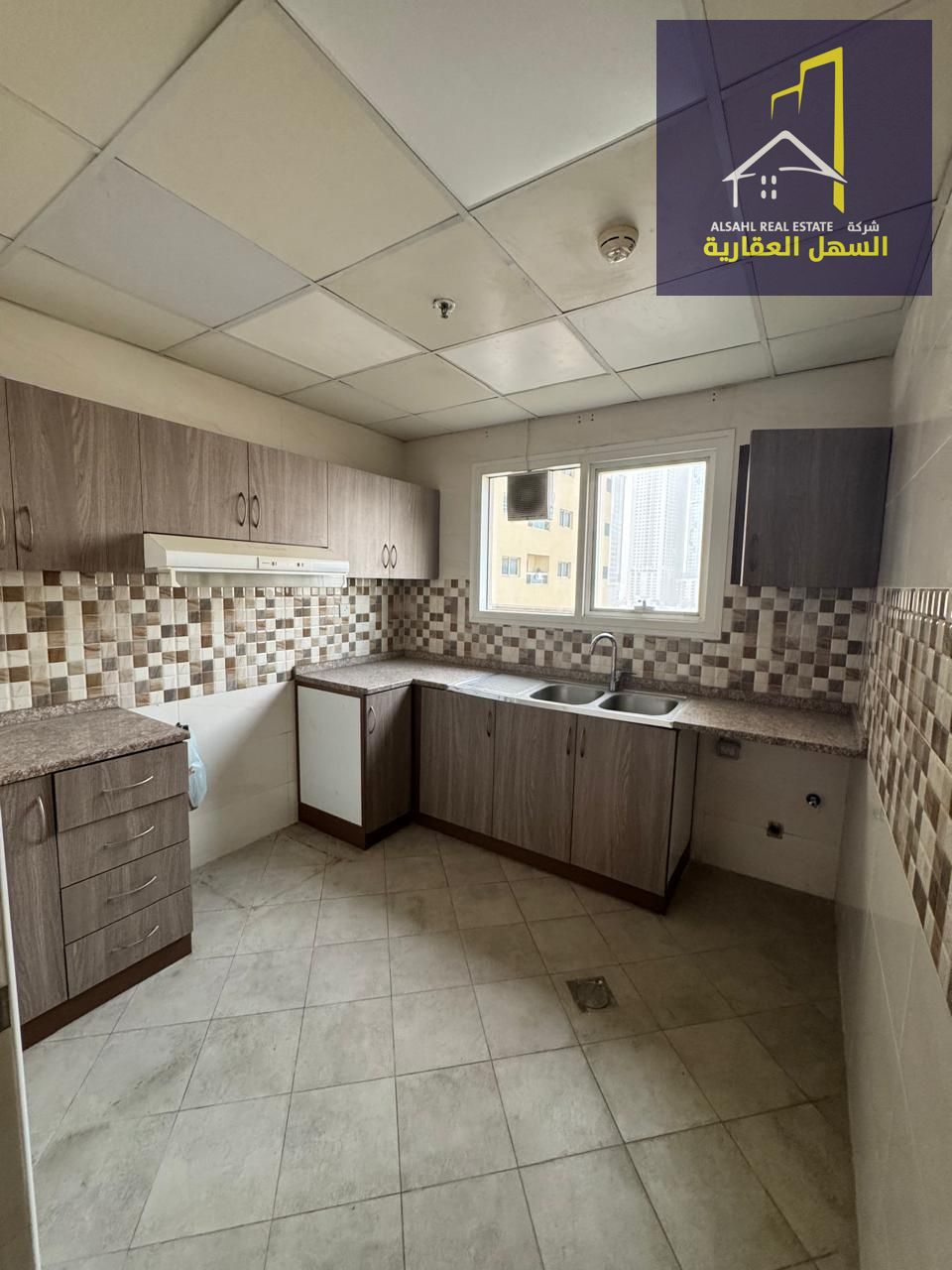Two-Bedroom Apartment with Living Room & Parking in Al Qasba – Prime Location