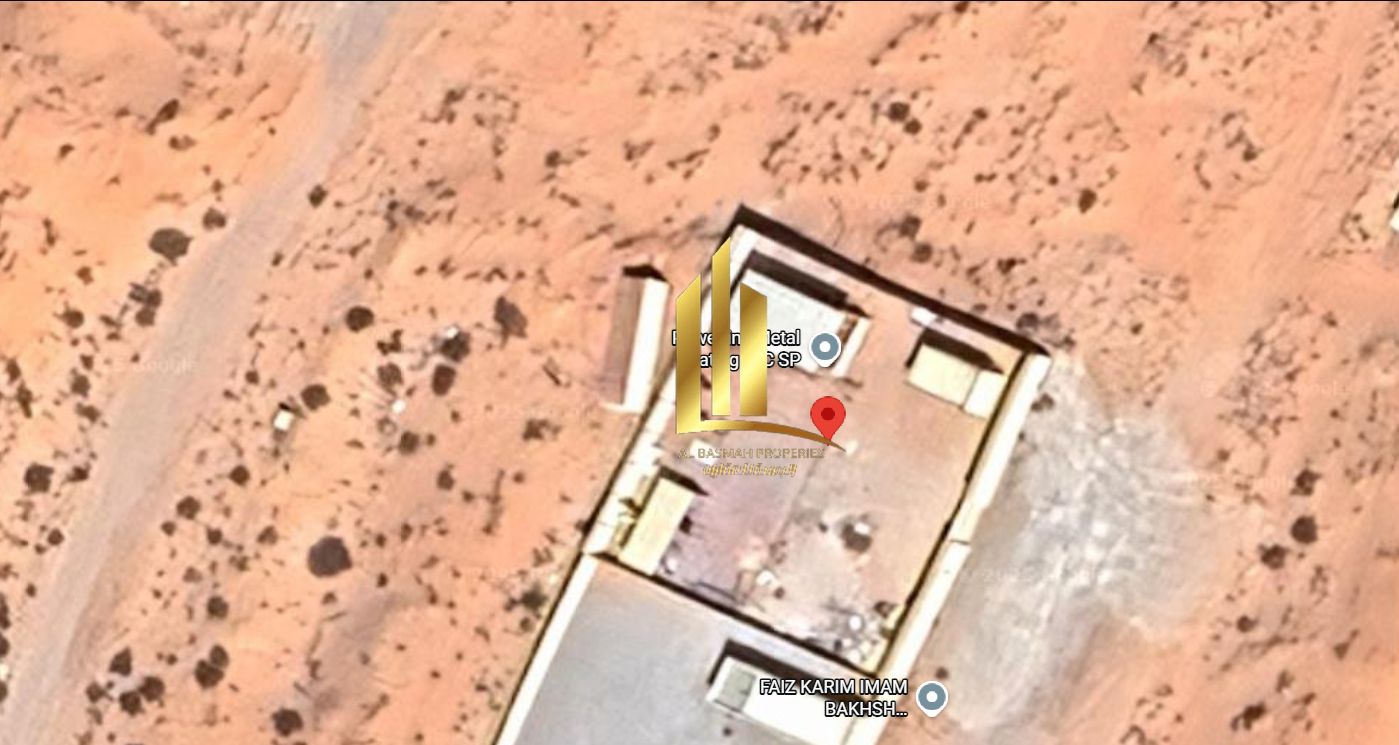 For sale: a fenced industrial plot in the Sajaa Industrial Area, ideally located for various industrial uses. The plot measures 10,800 square feet and