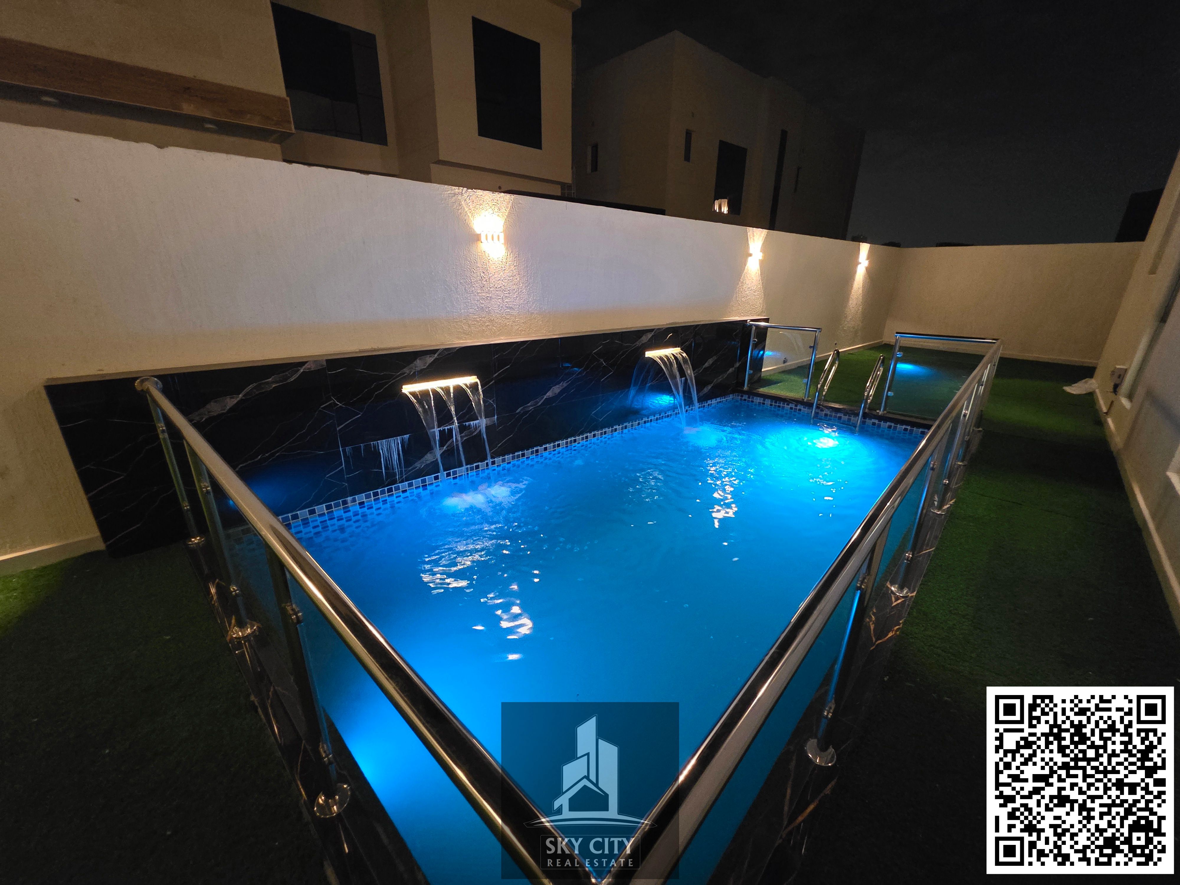 Al-Haliyo, Ajman, behind Emirates Towers, a villa ready for occupancy with electricity, water, air conditioning, registration and ownership fees included, private swimming pool, ground floor, first floor and roof, central air conditioning, corner lot on a